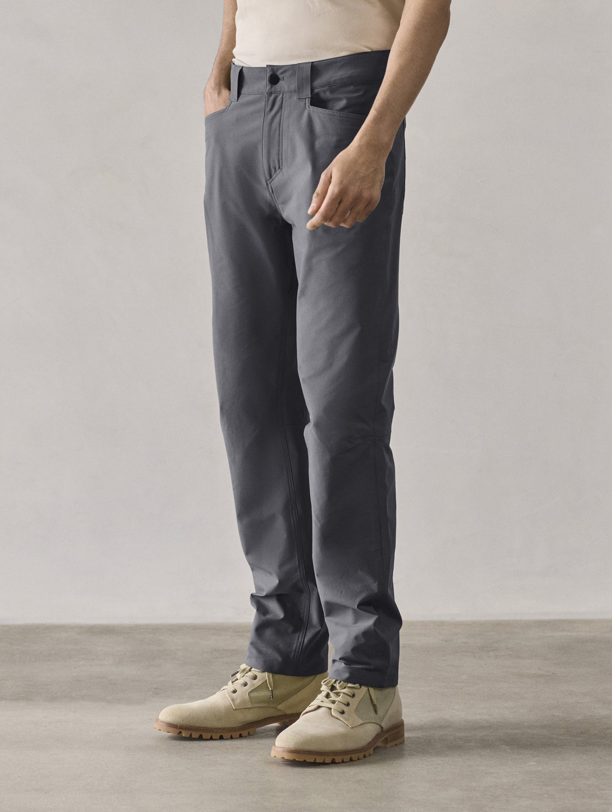 Front 3/4 lower-body view of man wearing Adventure Pant in Graphite from AETHER Apparel. 