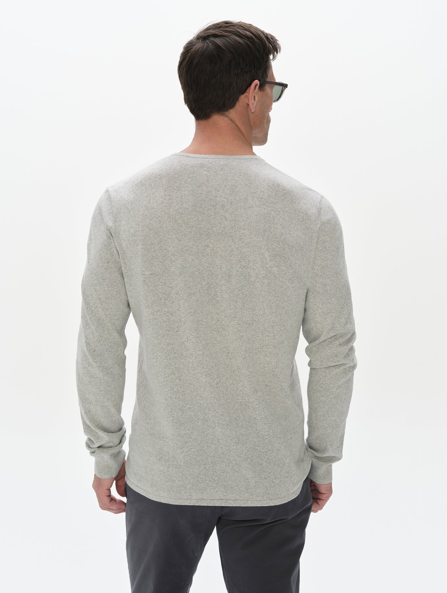 Rear, upper-body view of the man wearing the Aero Crewneck Sweater 2.0 in Alumino Grey from AETHER Apparel.