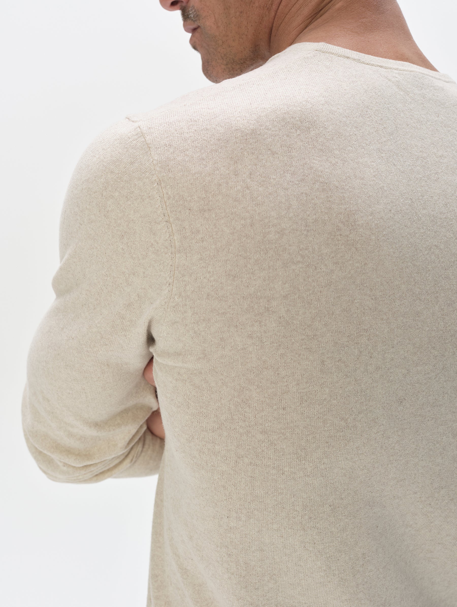 Closeup detailed view of the back shoulder of the men's Aero Crewneck Sweater 2.0 in Lino Tan from AETHER Apparel.