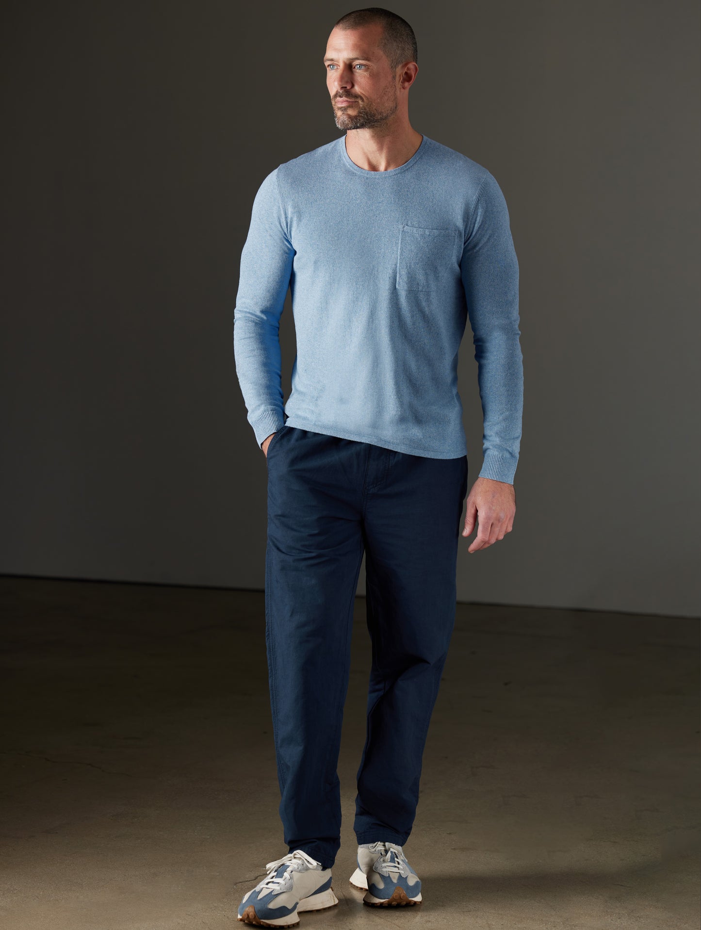 Man wearing a blue sweater from AETHER Apparel