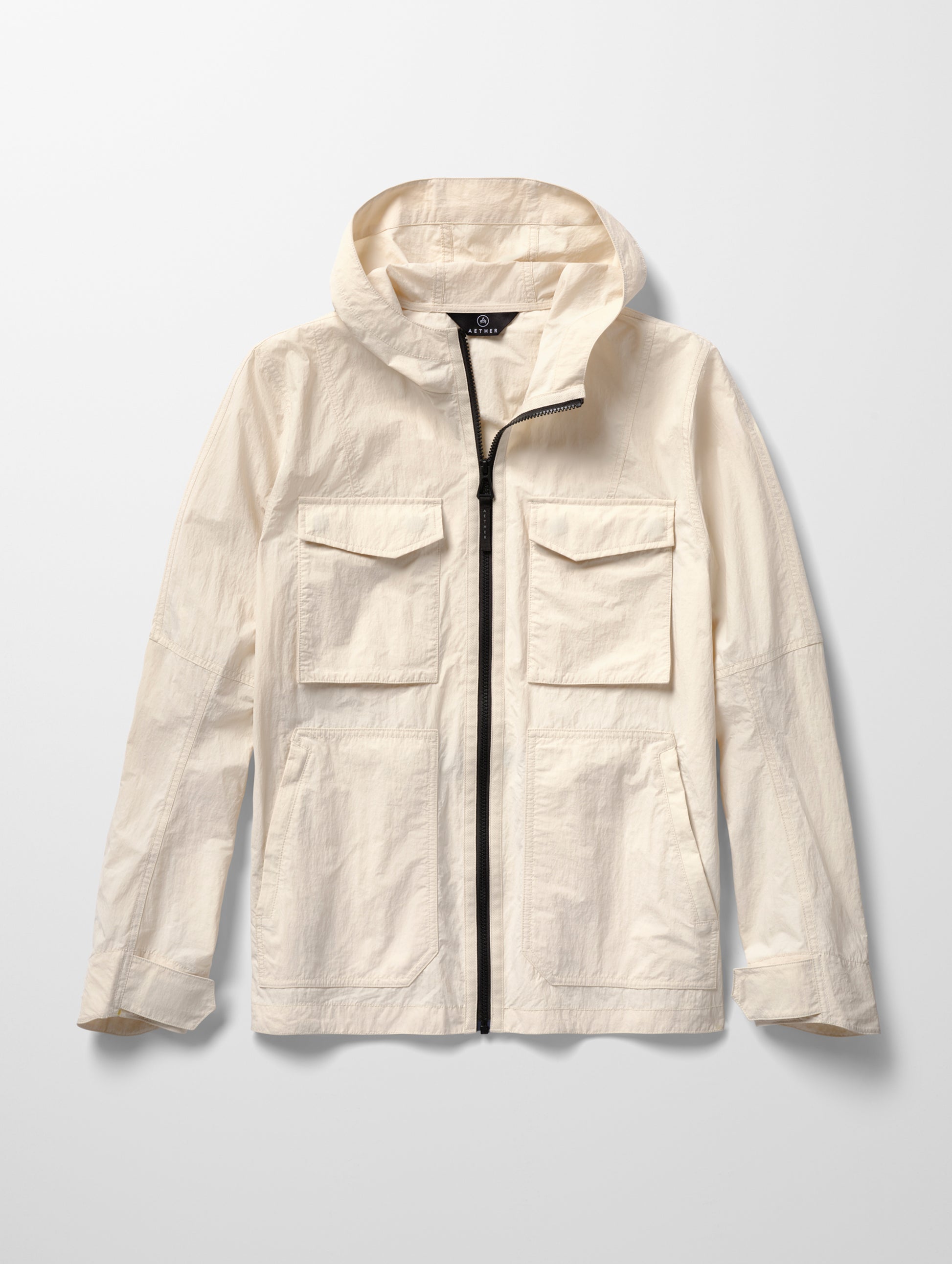 Flat lay image of men's Aires Lightweight Windbreaker in Bone white from AETHER Apparel.