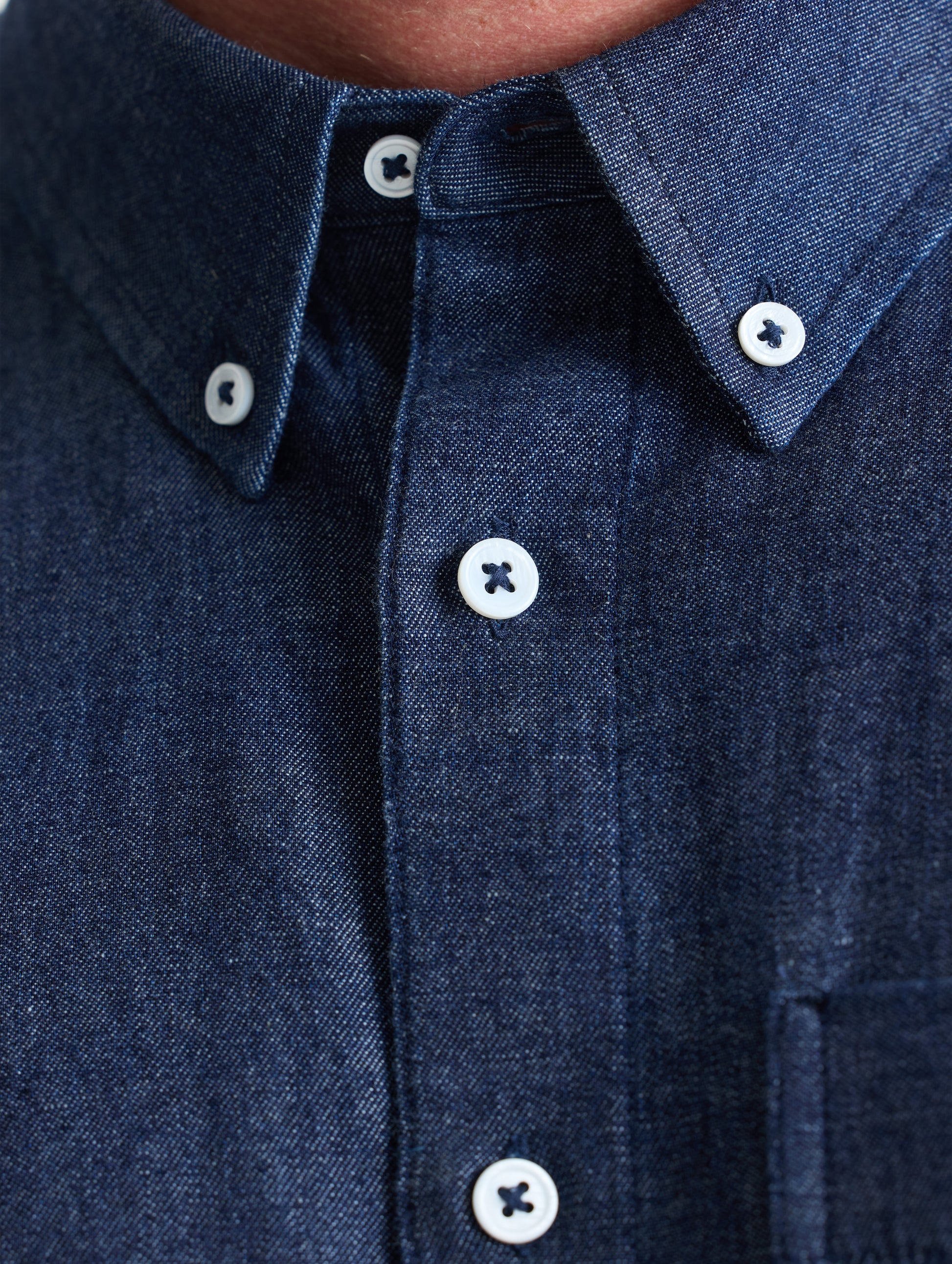 Closeup view of collar of Alder Chambray Button-Down in Dark Blue from AETHER Apparel.