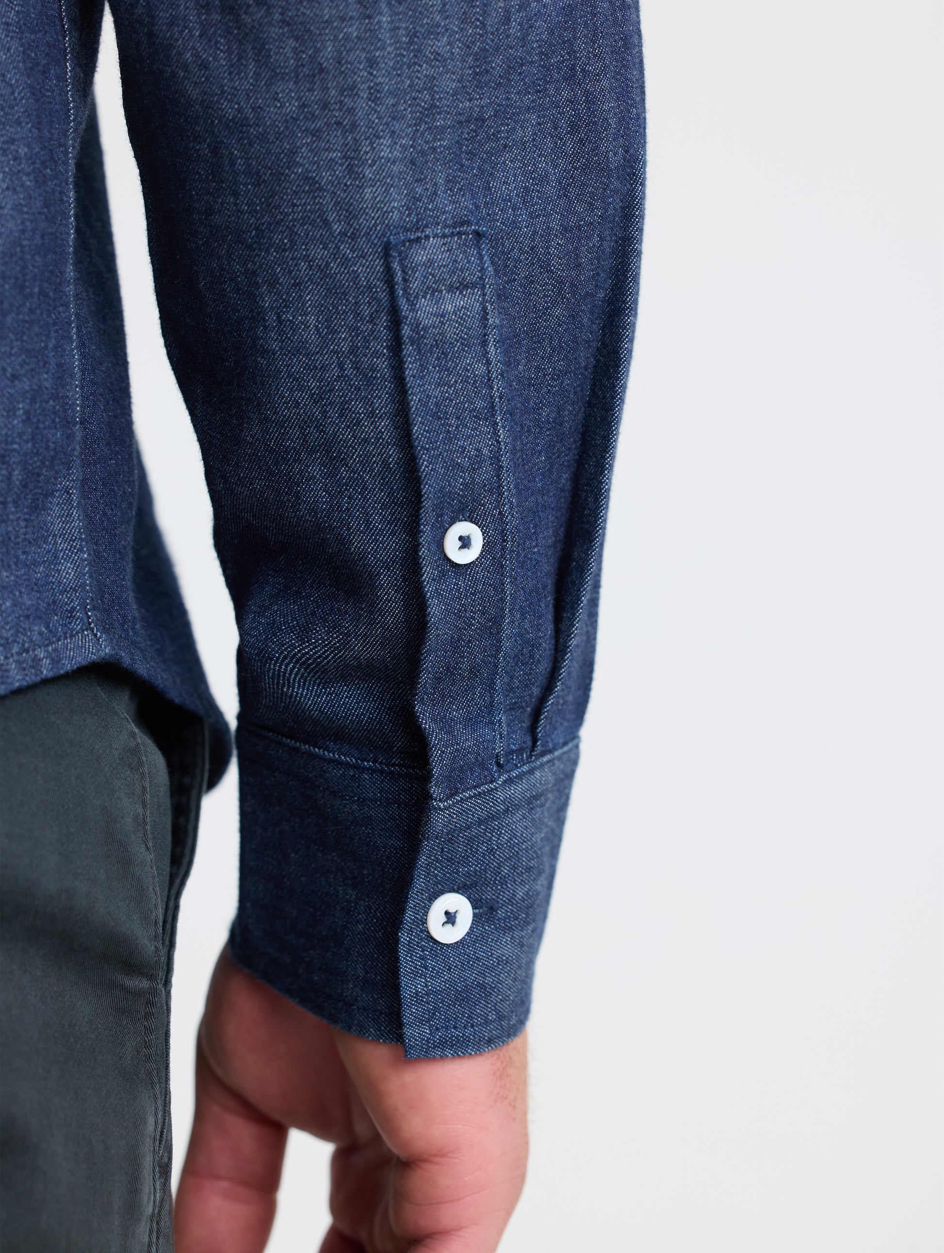 Rear closeup view of sleeve of Alder Chambray Button-Down in Dark Blue from AETHER Apparel.