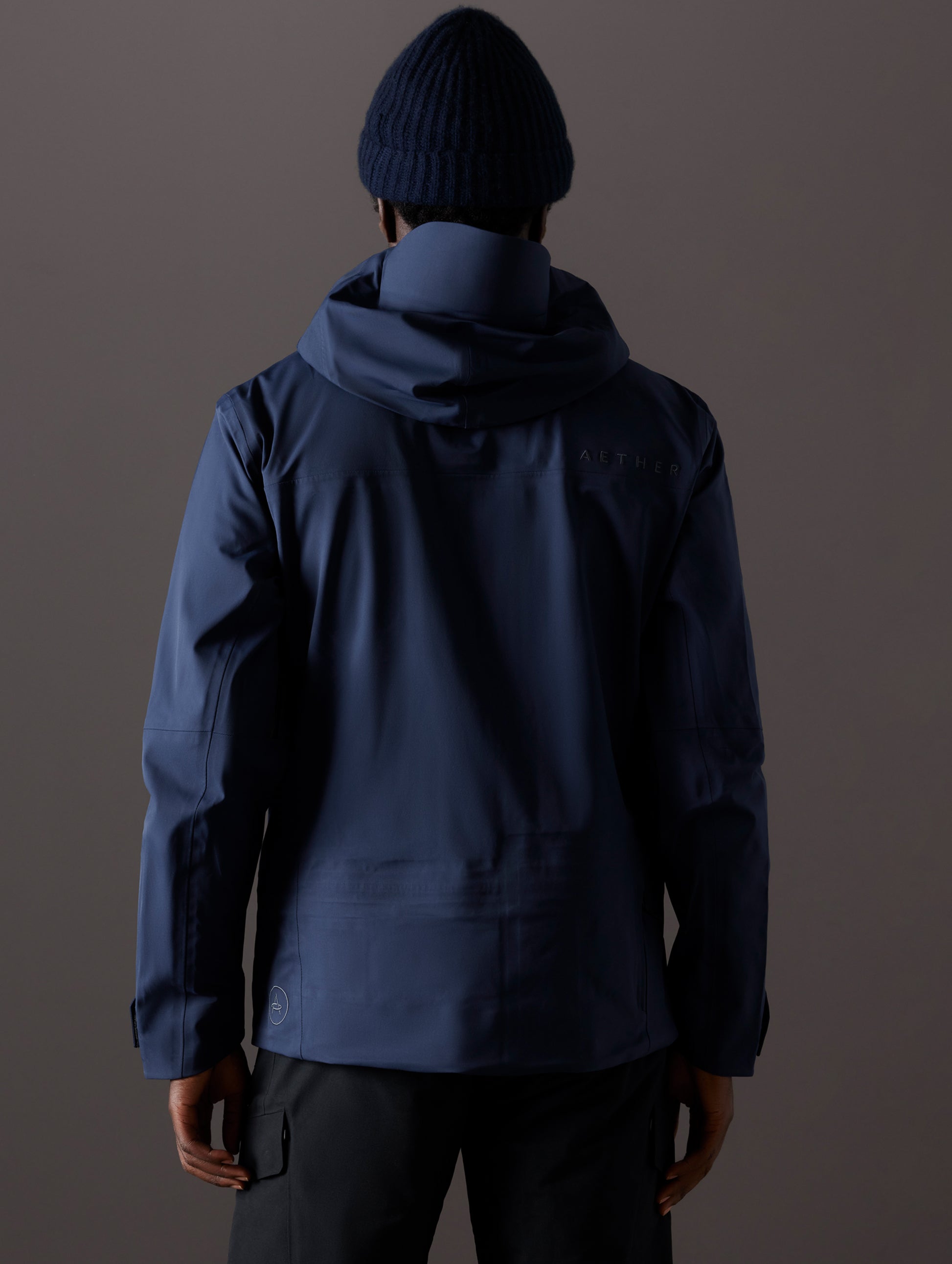 man wearing blue snow shell from AETHER Apparel