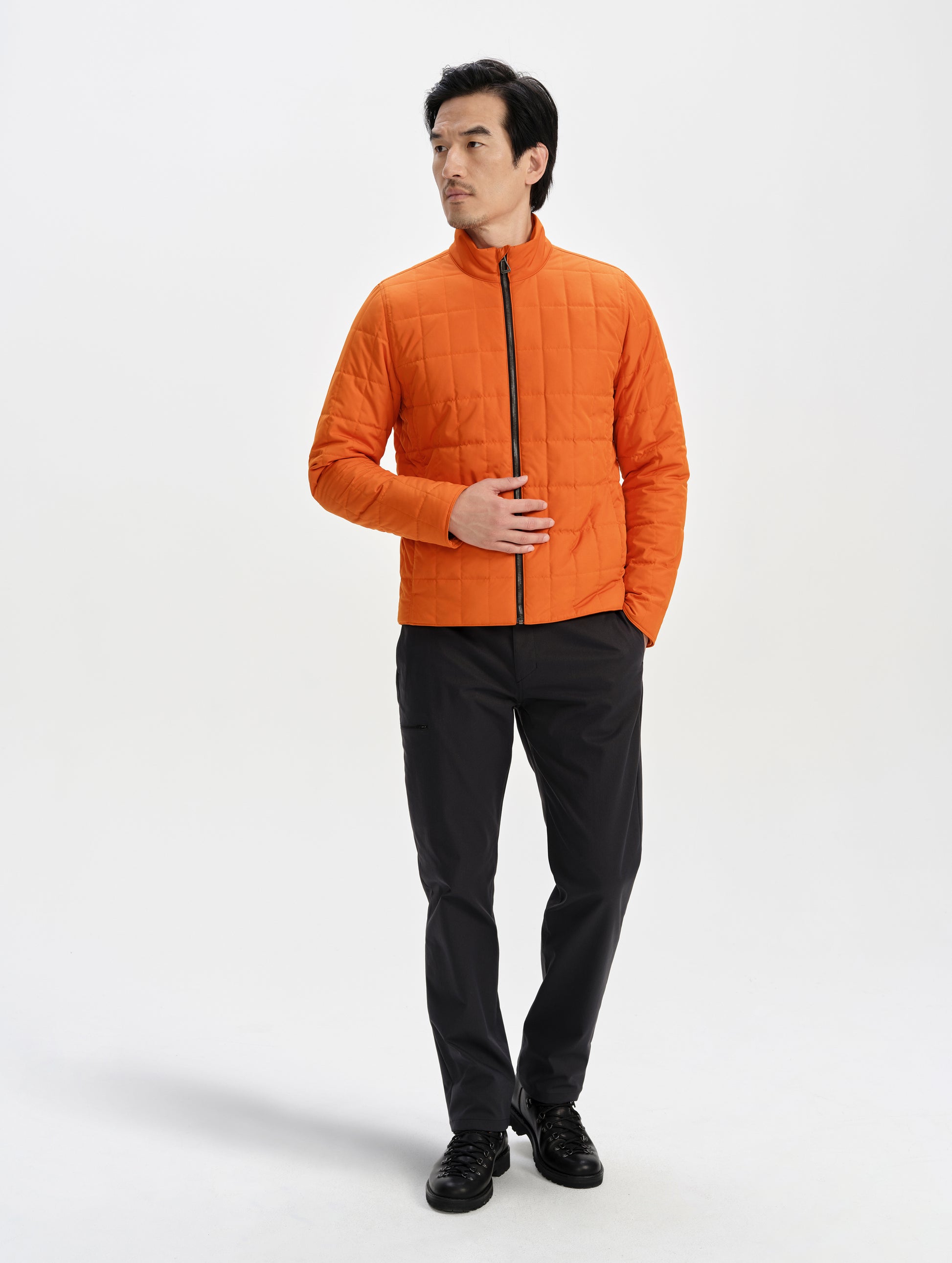 Front full-body view of man wearing the Alto Jacket 2.0 in Autumn Orange from AETHER Apparel.