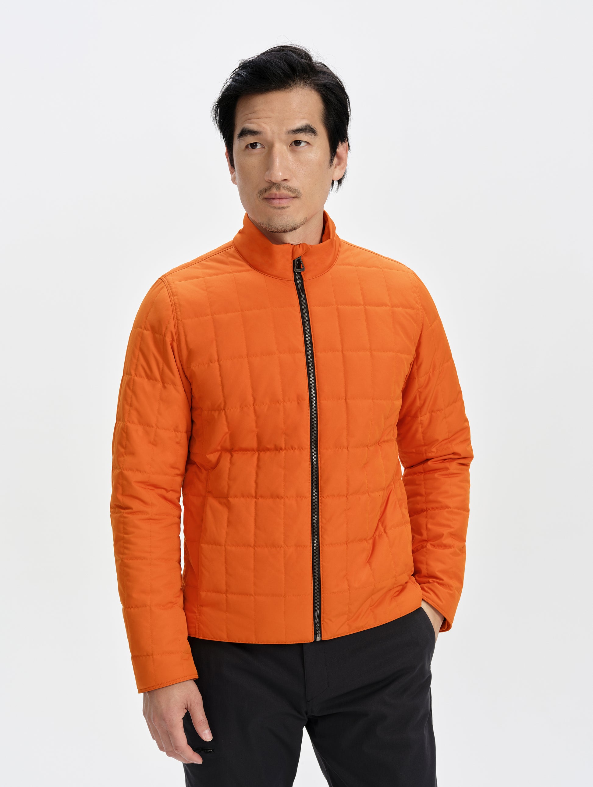 Front upper-body view of man wearing the Alto Jacket 2.0 in Autumn Orange from AETHER Apparel.