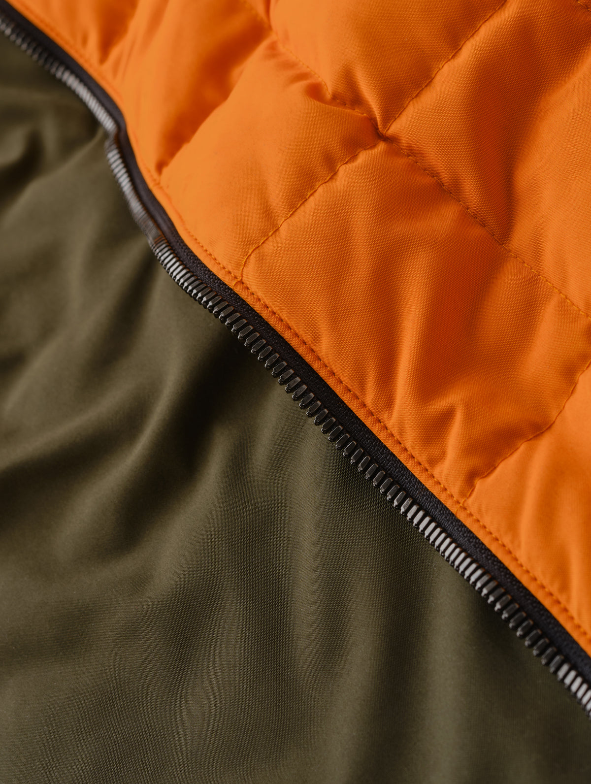 Closeup detailed view of the Forest Green lining on the Alto Jacket 2.0 in Autumn Orange from AETHER Apparel.