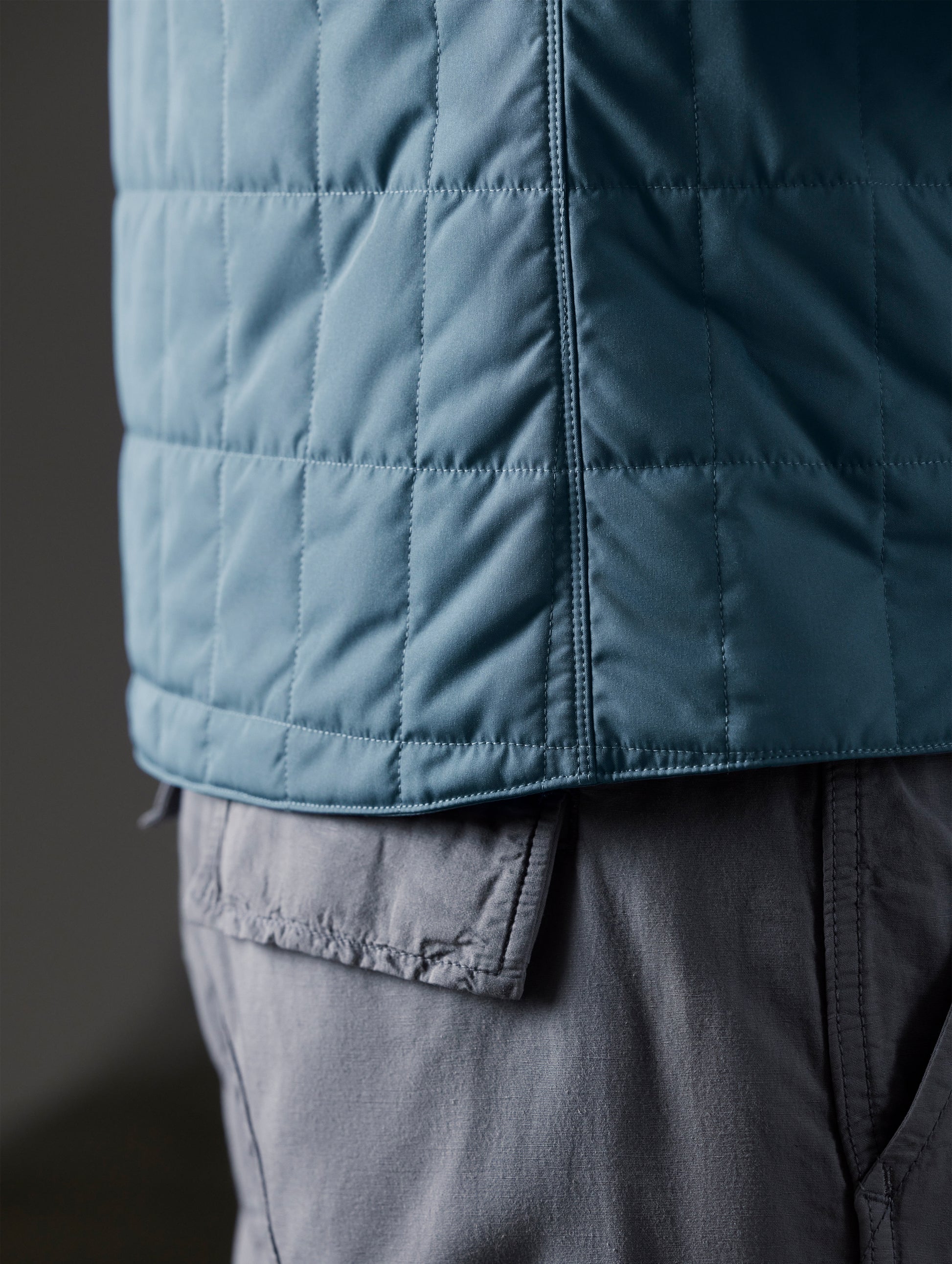 Closeup detailed view of the side seam and quilted shell on the Alto Jacket 2.0 in Portal Blue from AETHER Apparel.