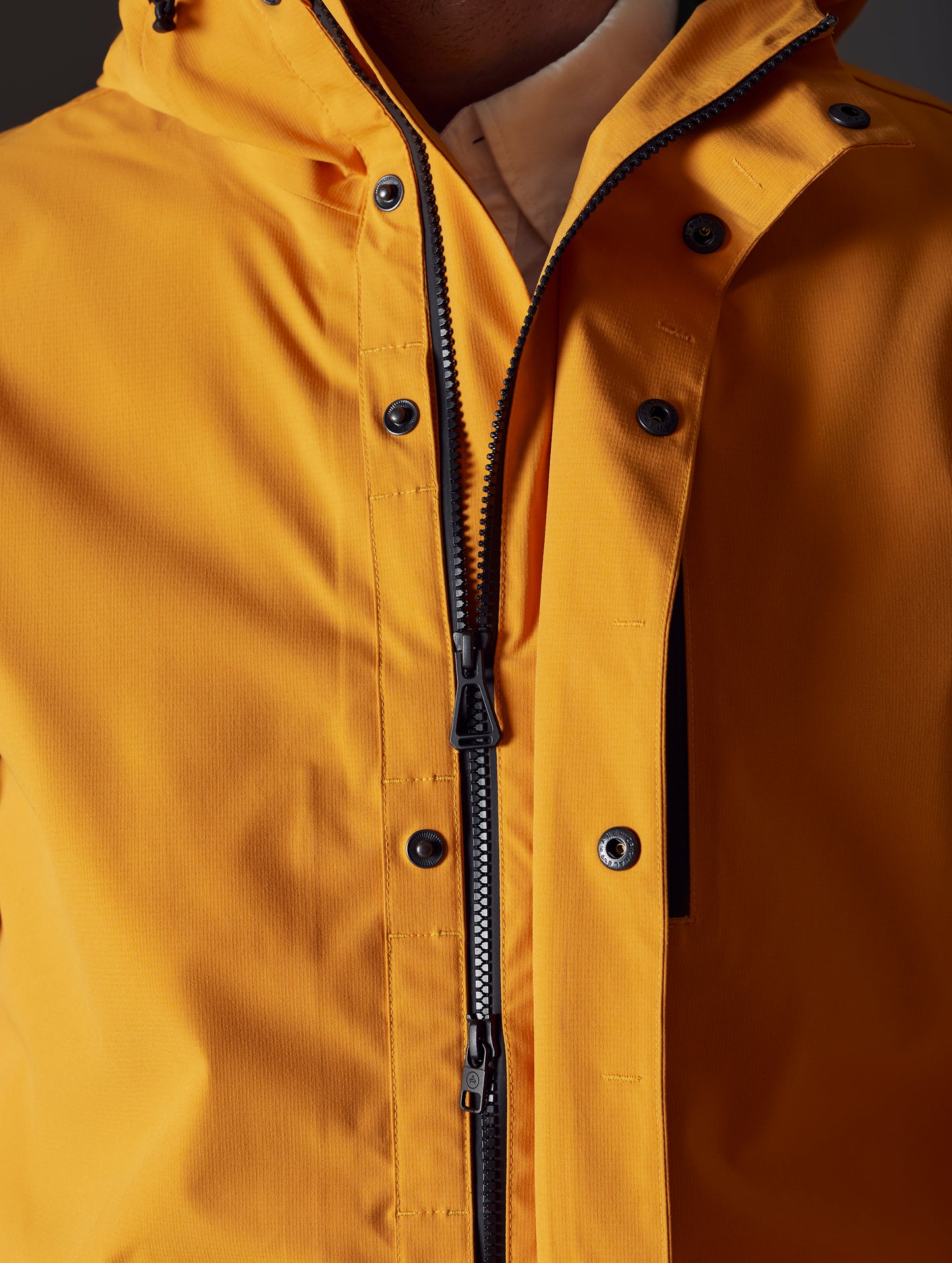 Men's orange rain jacket from AETHER Apparel