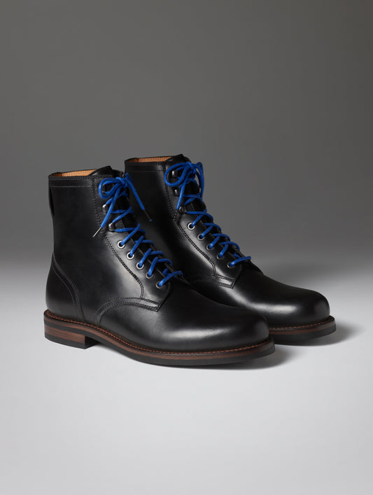 Front angled view of the Avenue Boot in Onyx Black with blue laces from AETHER Apparel.