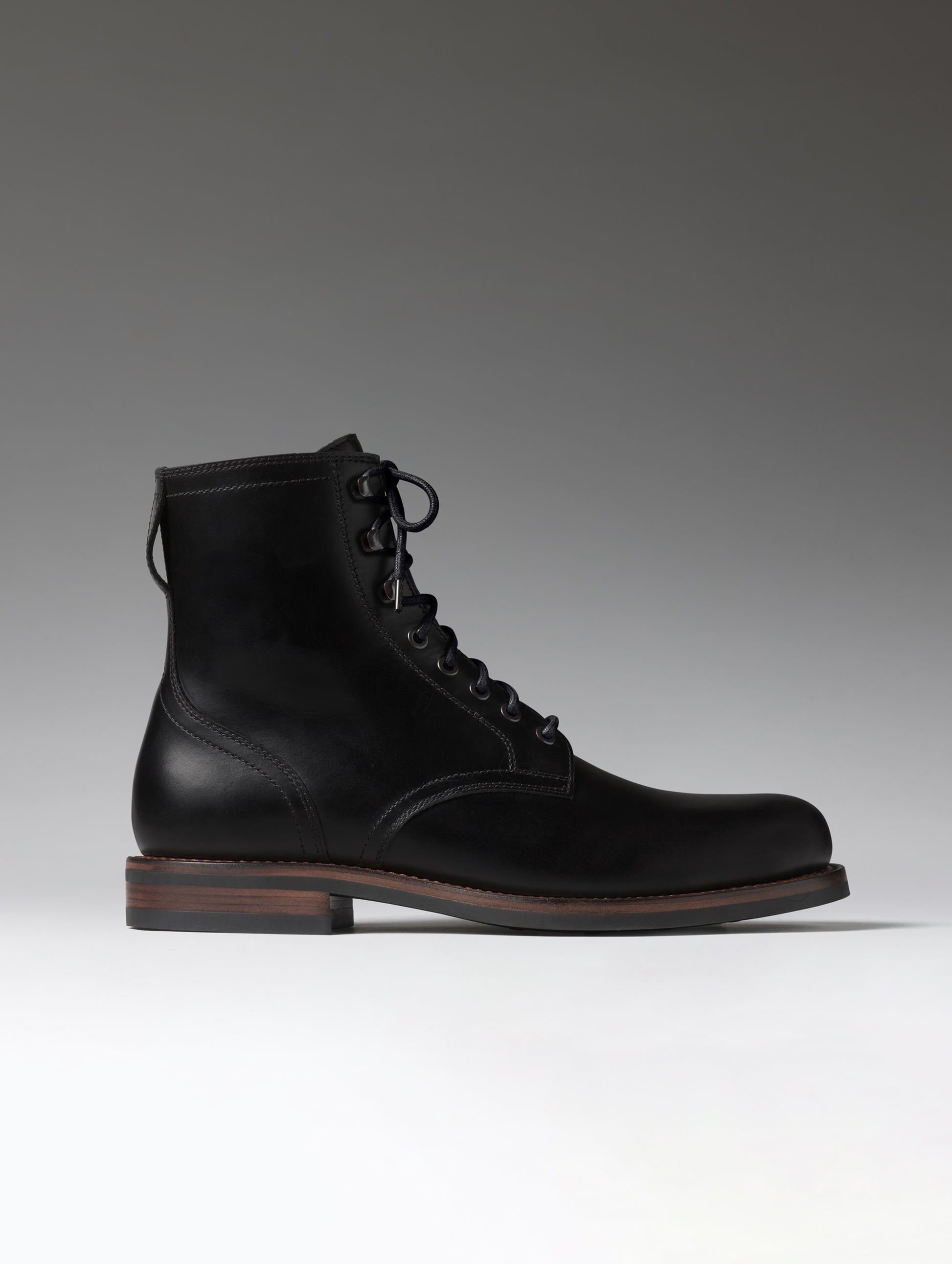 Side profile view of the Avenue Boot in Onyx Black from AETHER Apparel.