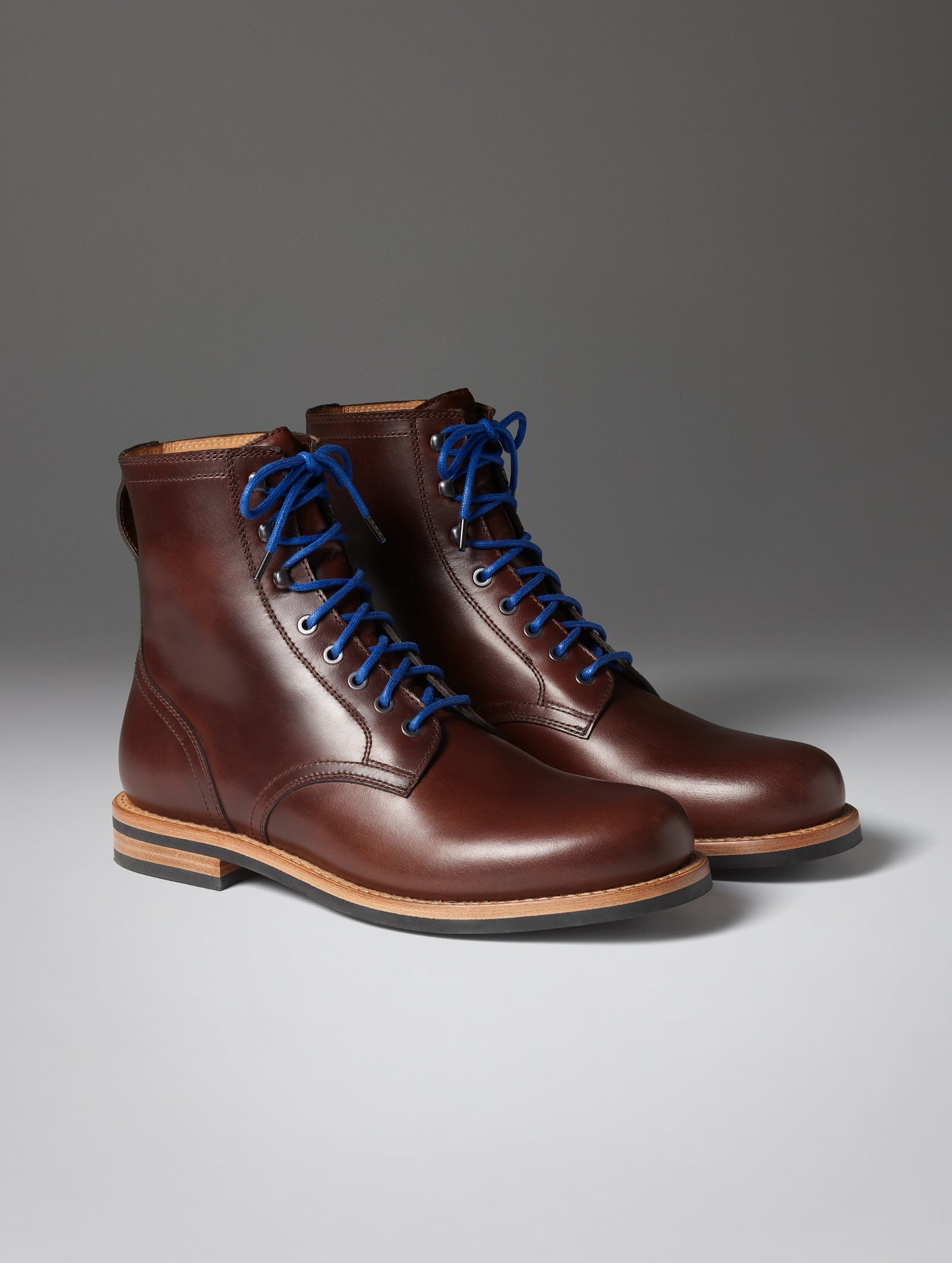 Front angled view of the Avenue Boot in Rustic Brown with blue laces from AETHER Apparel.