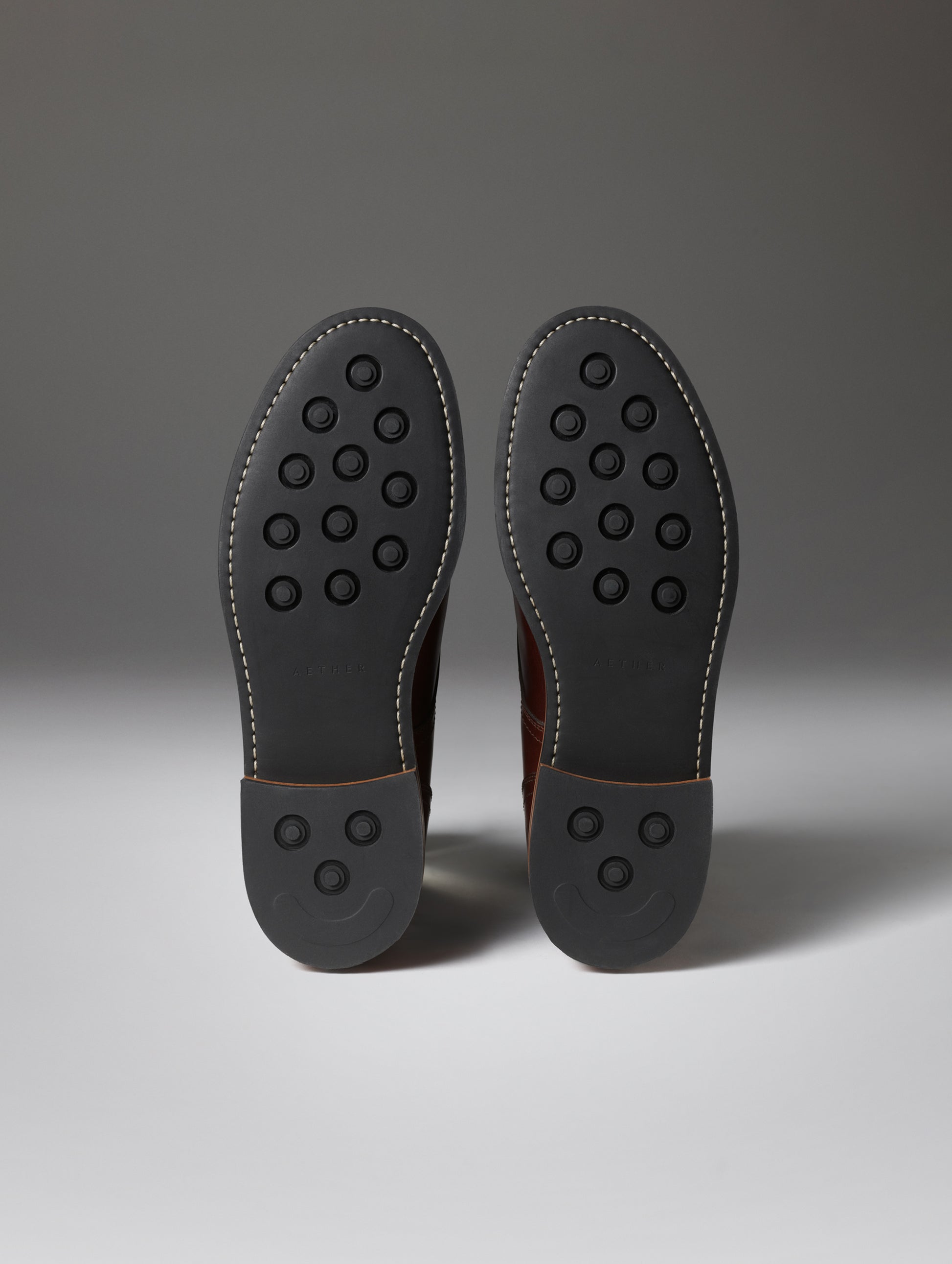 Bottom view of the rubber outsoles on the Avenue Boot in Rustic Brown from AETHER Apparel.
