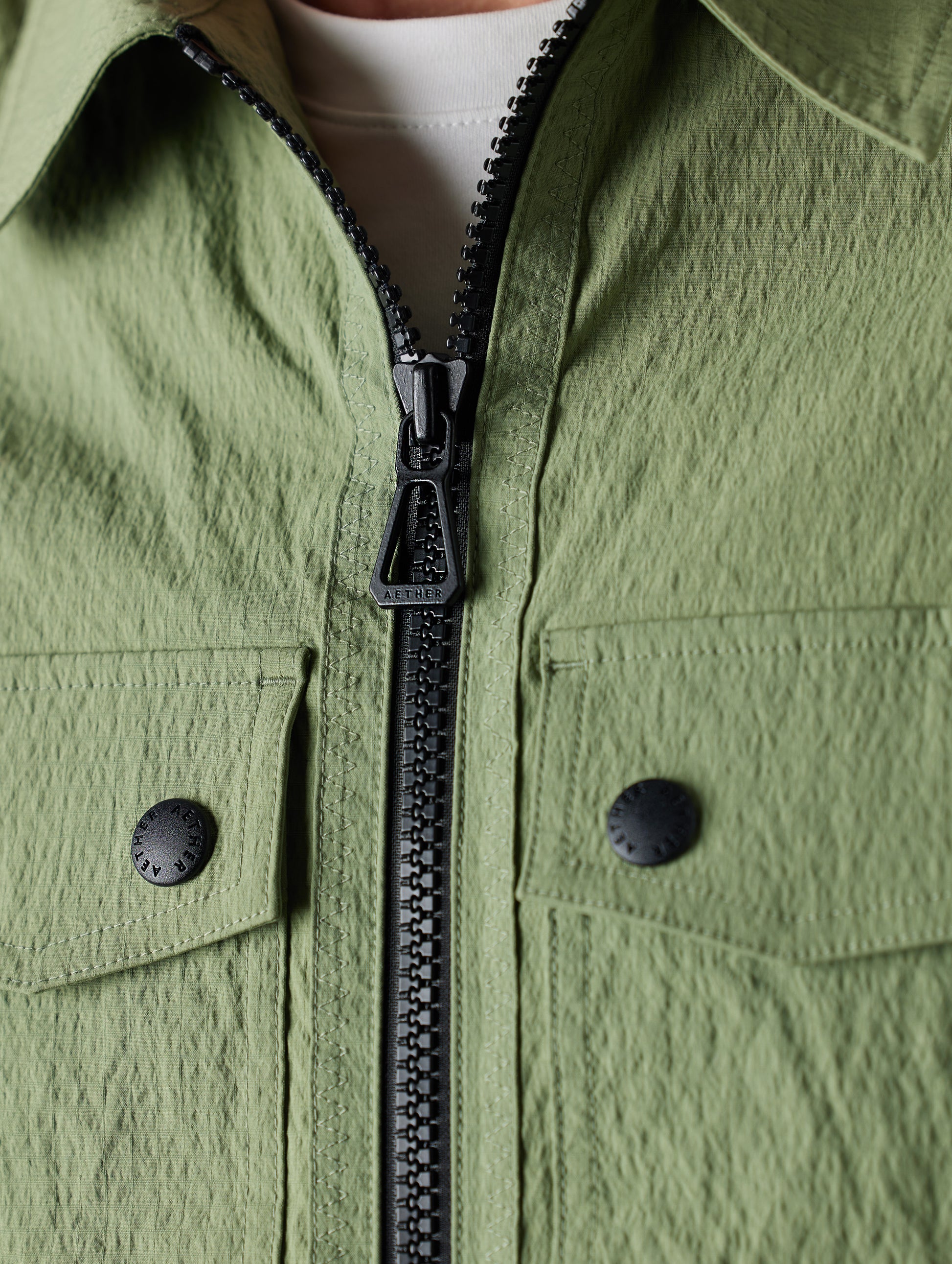 Close-up of green jacket from AETHER Apparel