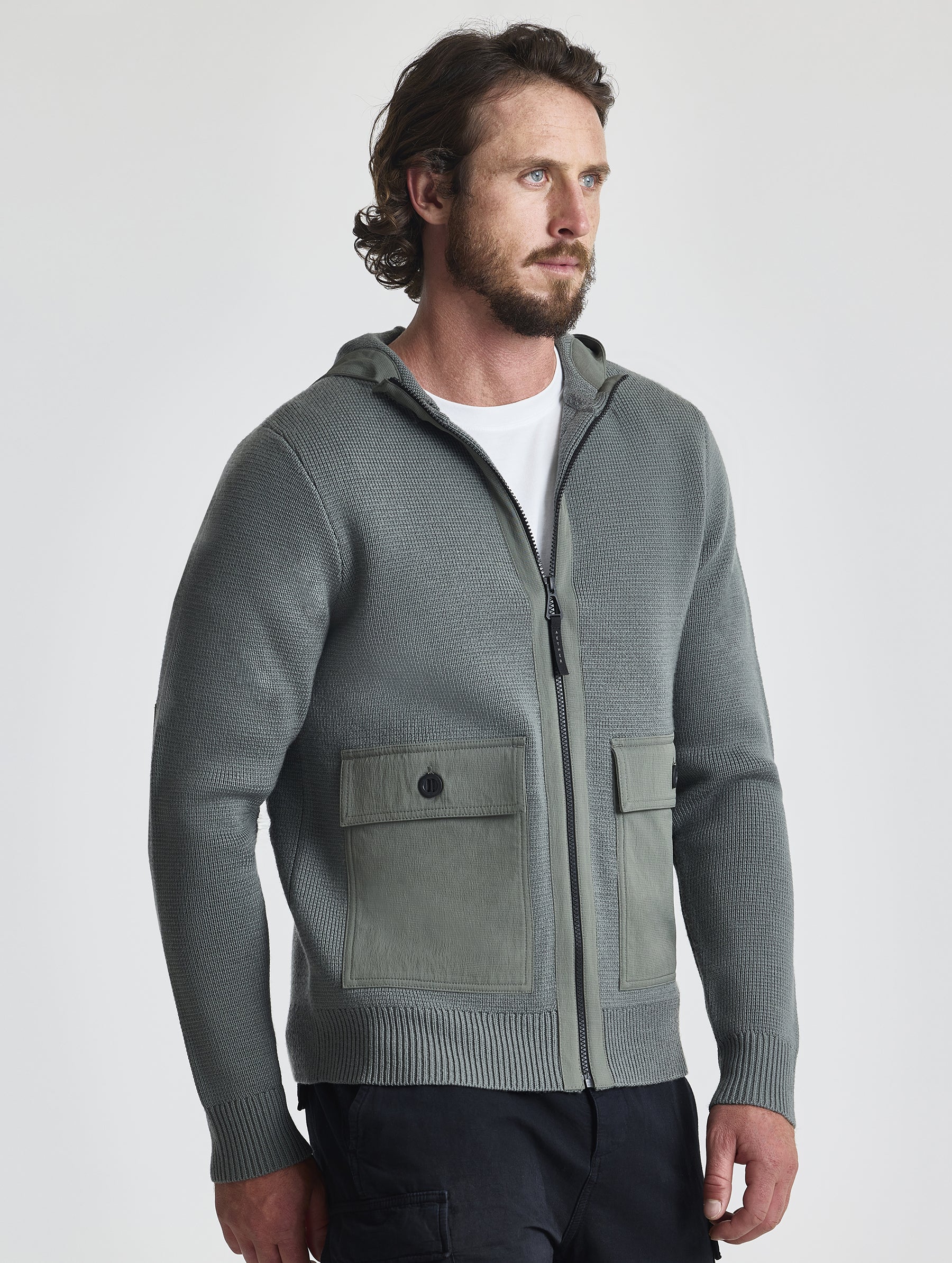 Angled view of man wearing Benson Full-Zip Sweater in Gunmetal grey from AETHER Apparel.