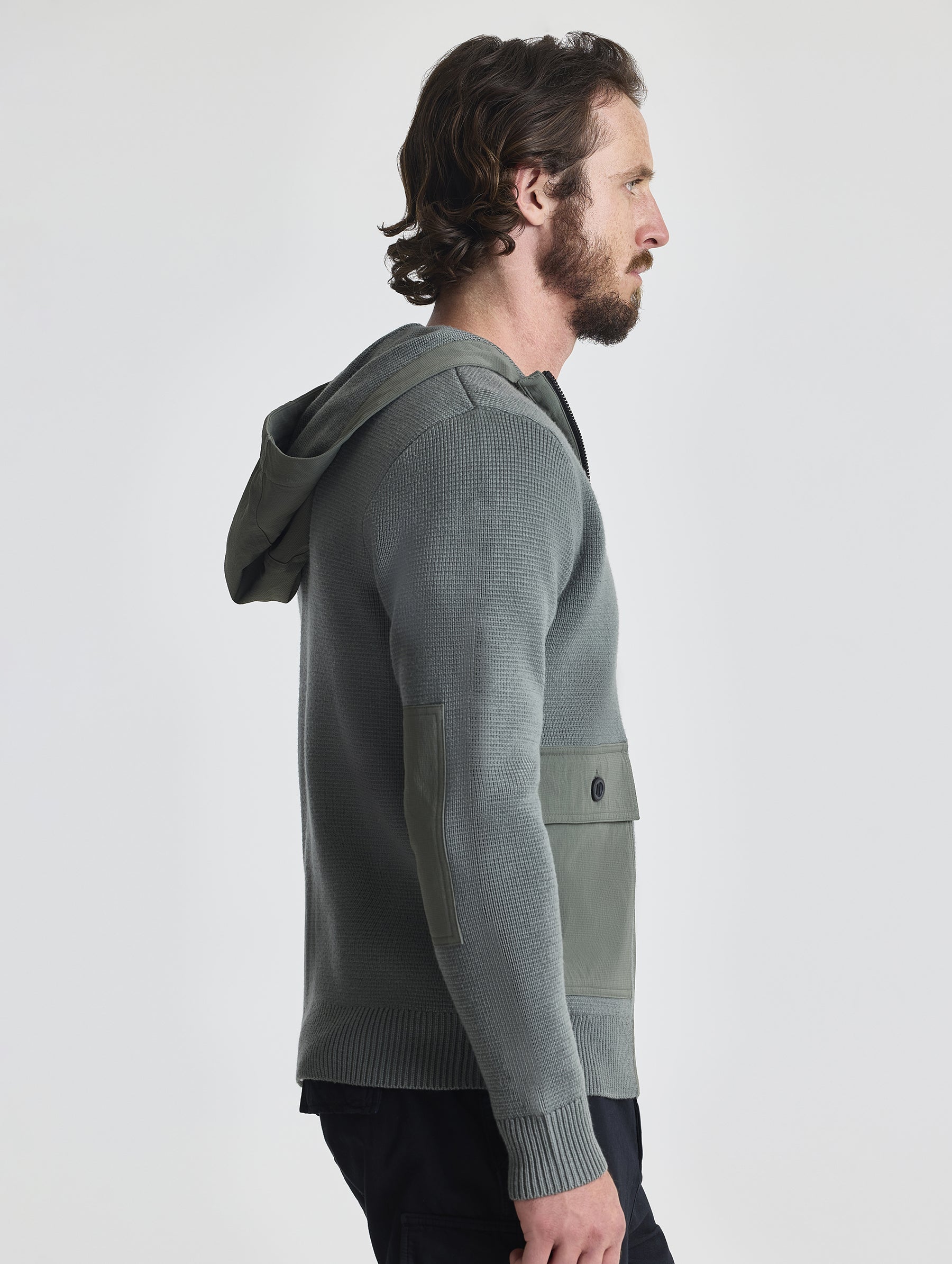 Right profile of man wearing Benson Full-Zip Sweater in Gunmetal grey from AETHER Apparel.