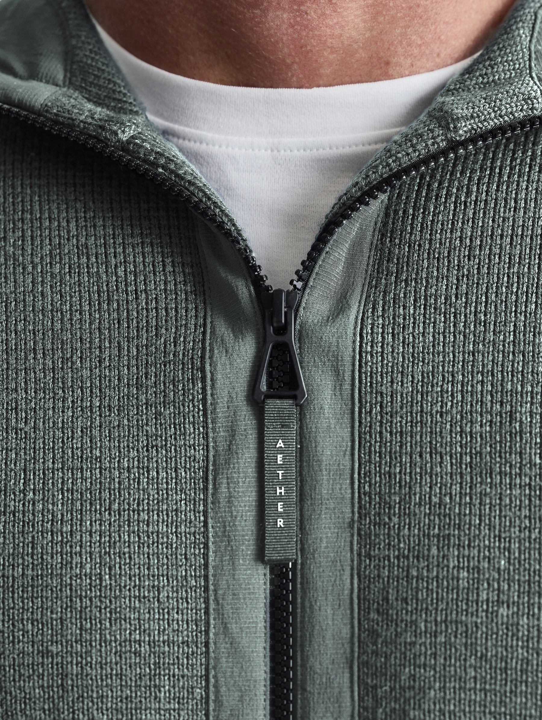 Closeup view of collar of Benson Full-Zip Sweater in Gunmetal grey from AETHER Apparel.