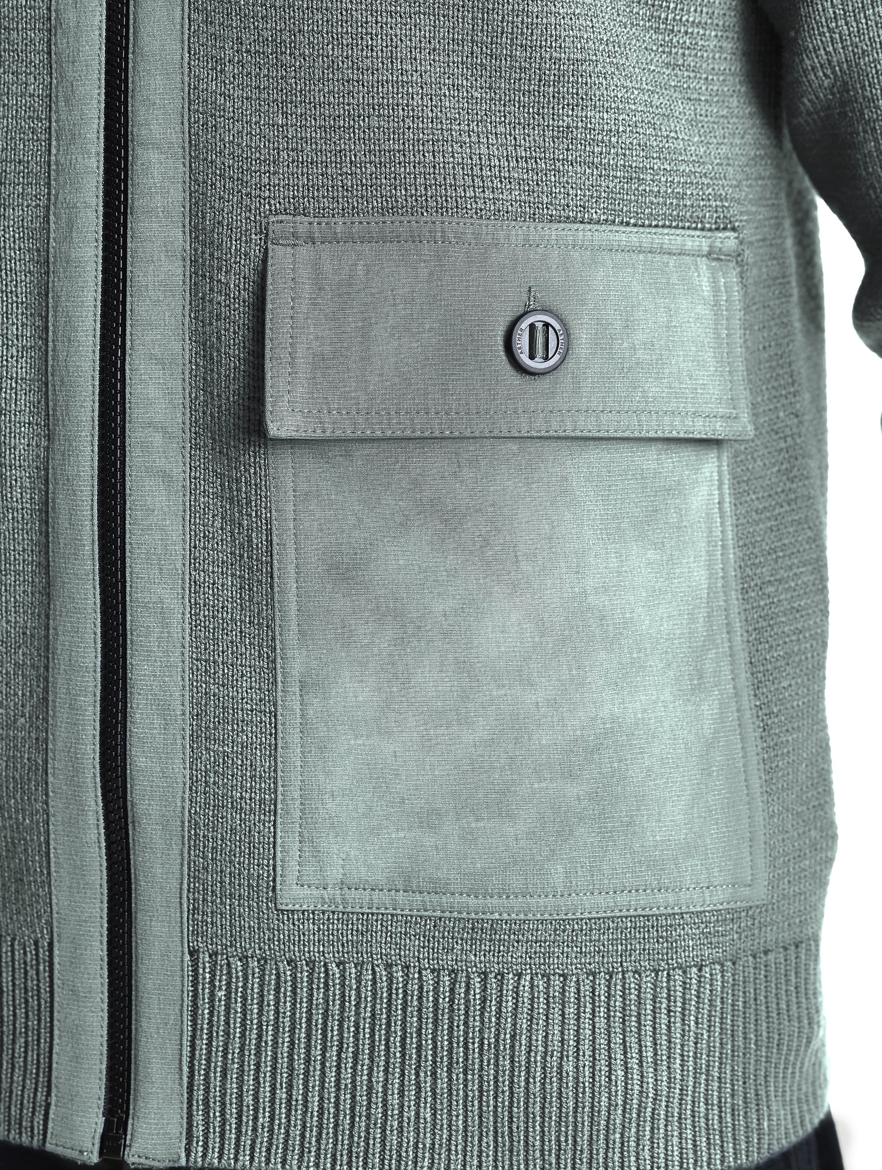 Closeup view of wearer's left patch pocket of Benson Full-Zip Sweater in Gunmetal grey from AETHER Apparel.