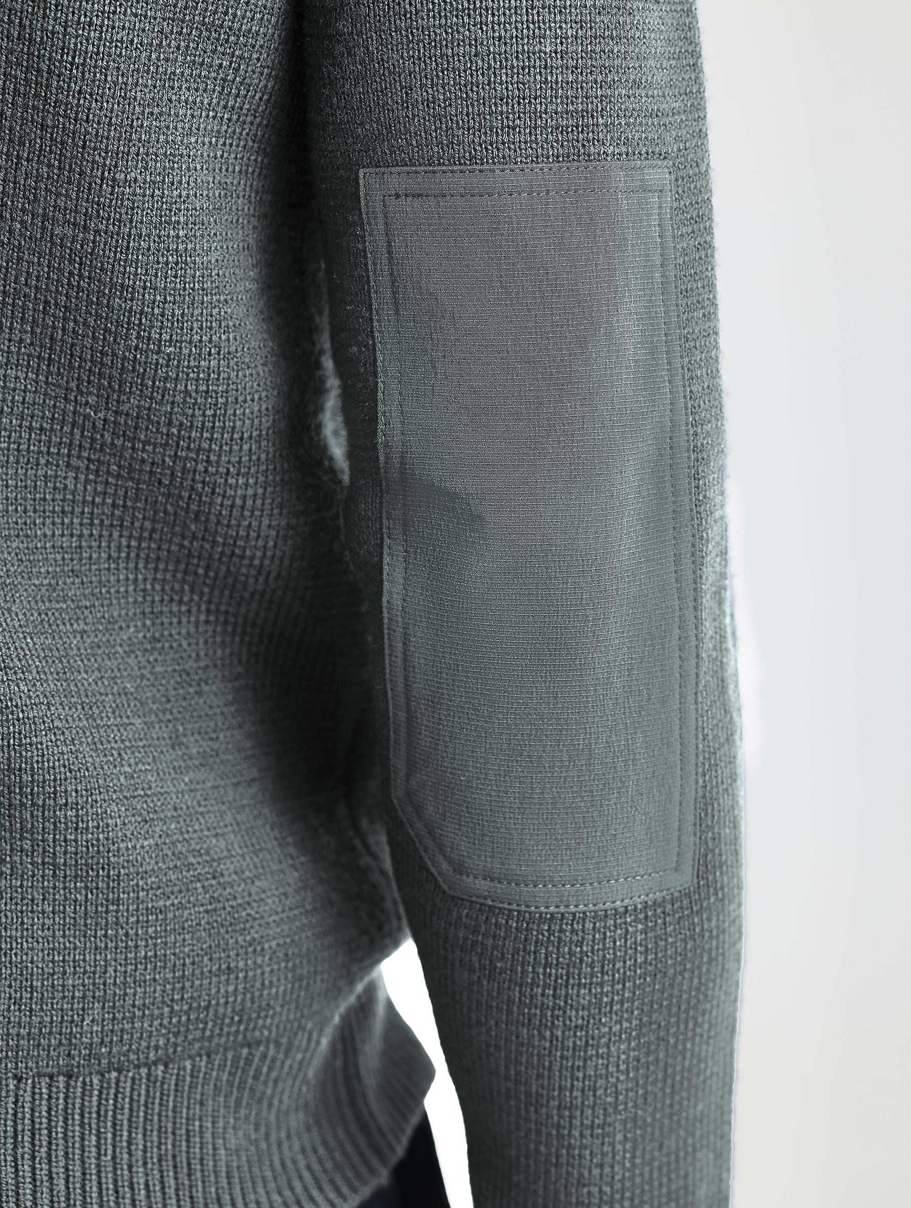 Closeup view of wearer's right elbow patch of Benson Full-Zip Sweater in Gunmetal grey from AETHER Apparel.
