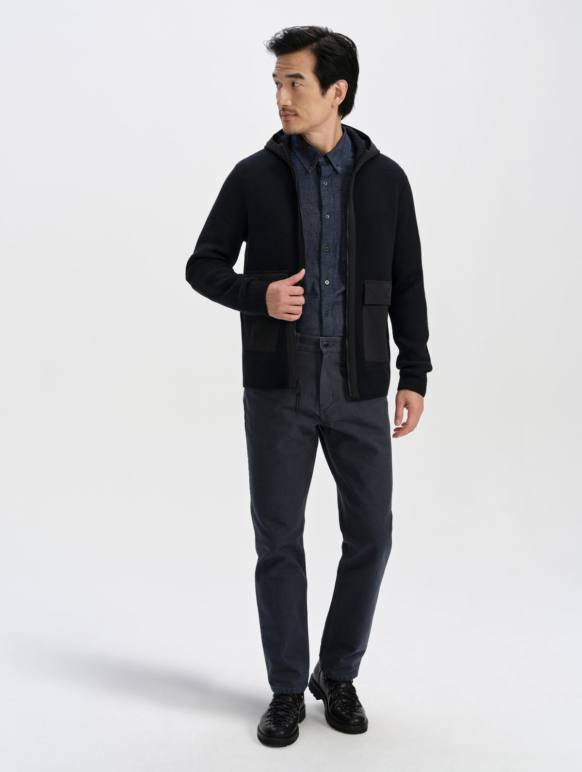Front full-body view of man wearing the Benson Full-Zip Sweater in Onyx Black from AETHER Apparel.
