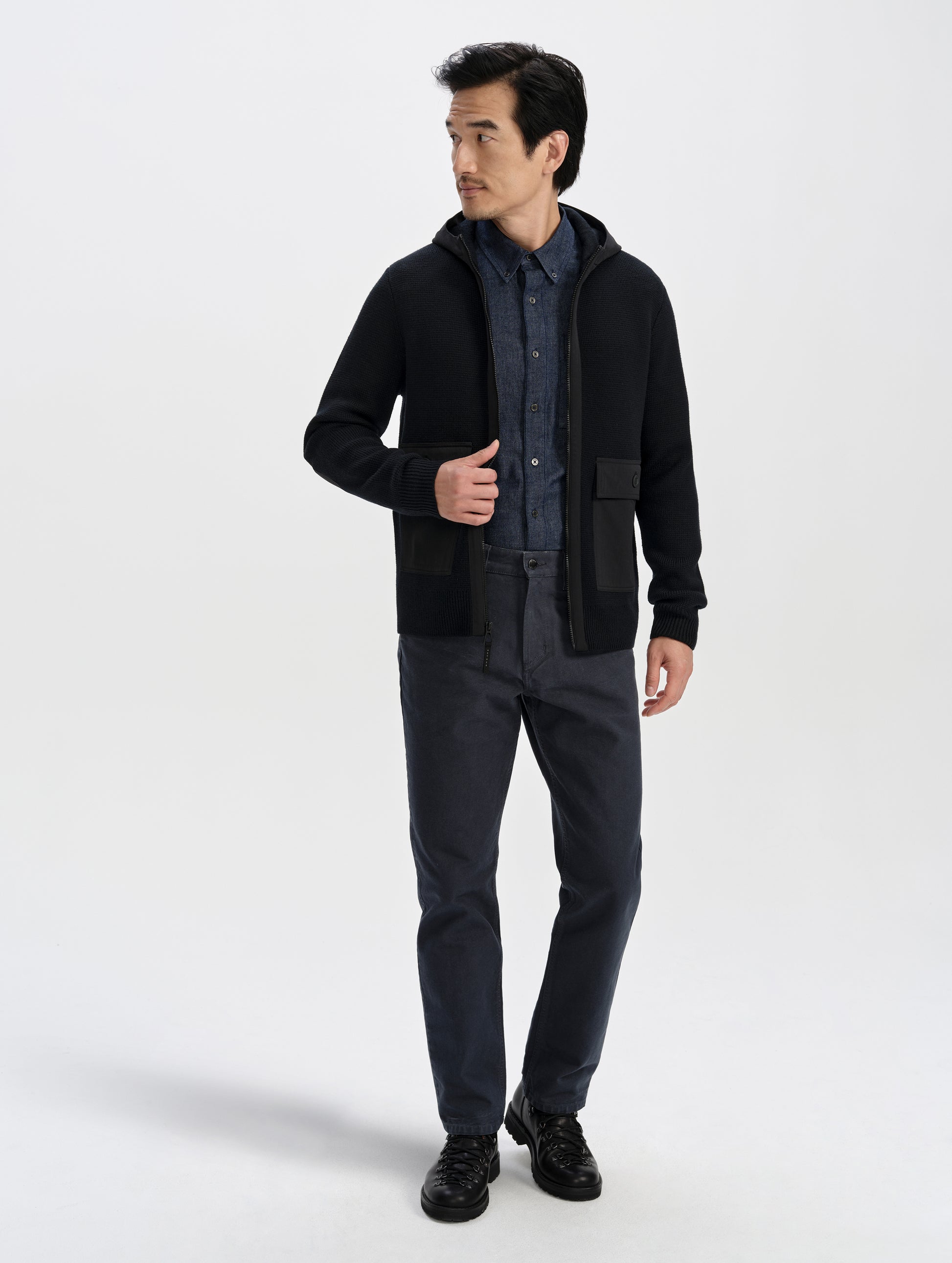 Front full-body view of man wearing the Benson Full-Zip Sweater in Onyx Black from AETHER Apparel.