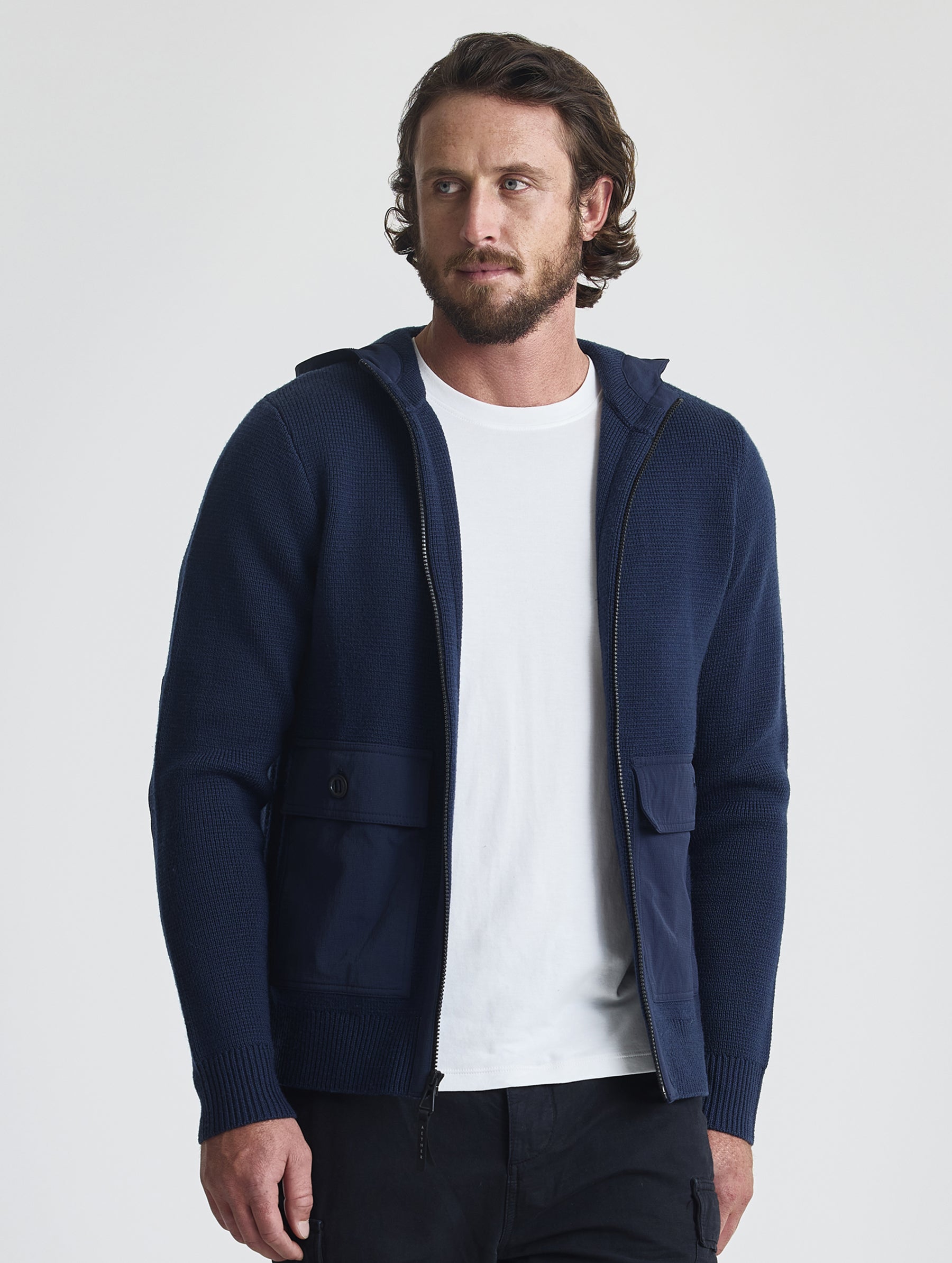 Front view of man wearing Benson Full-Zip Sweater in Total Eclipse dark blue from AETHER Apparel.