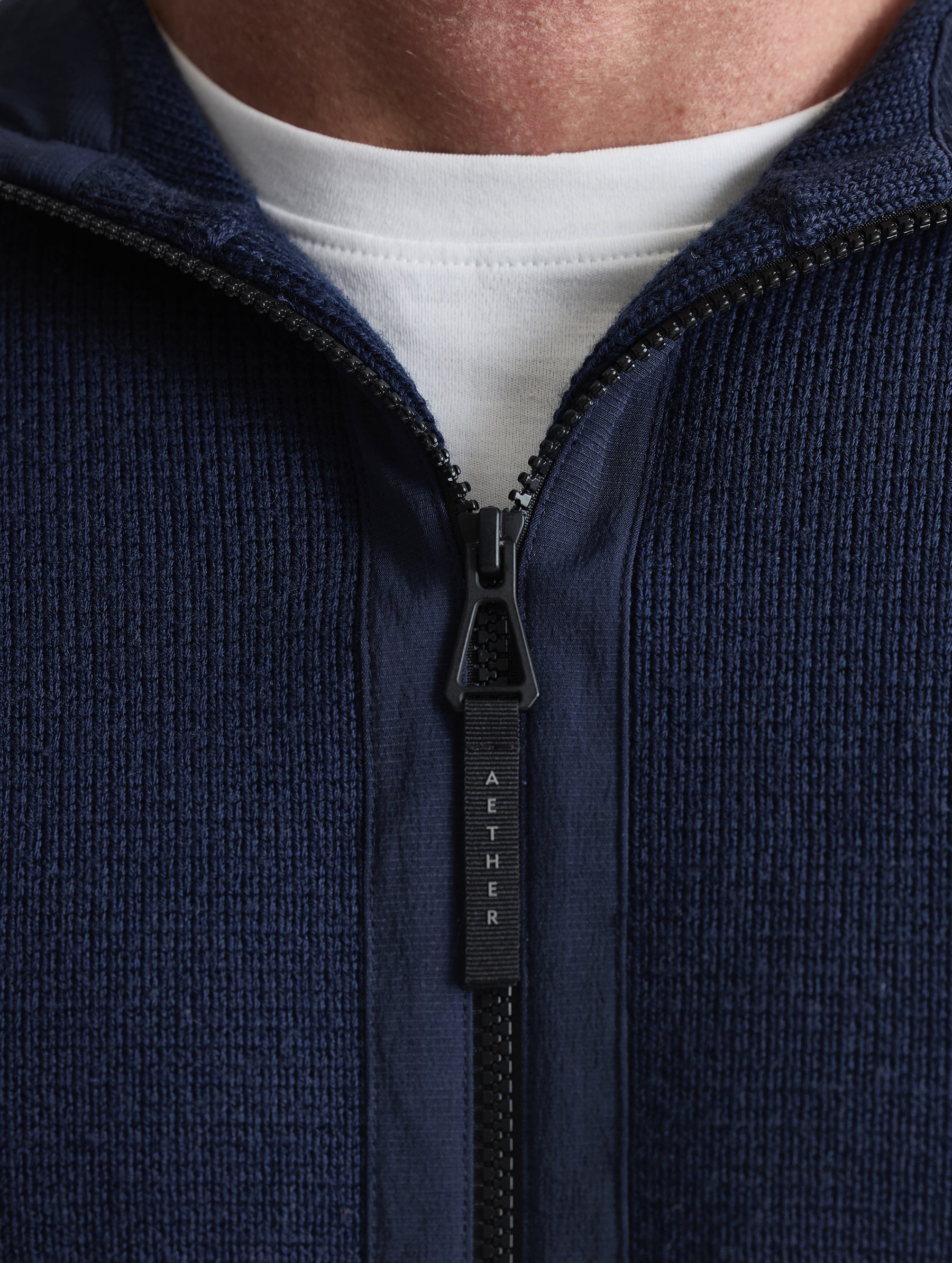 Closeup view of collar of Benson Full-Zip Sweater in Total Eclipse dark blue from AETHER Apparel.