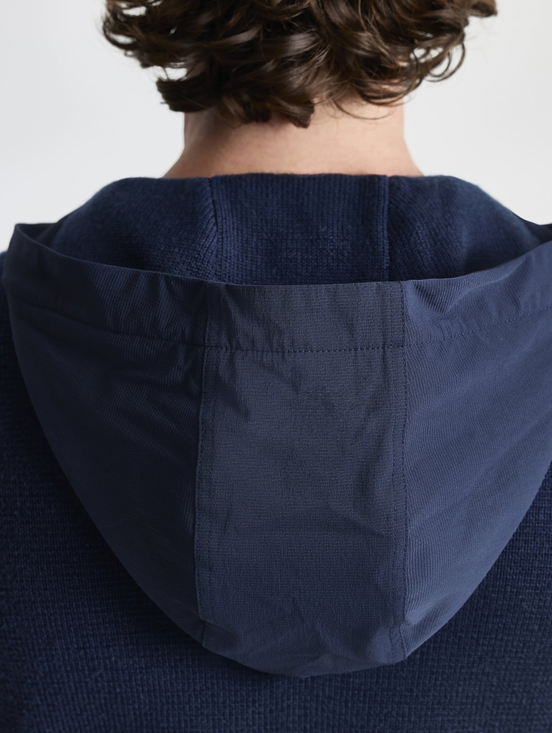 Rear closeup view of hood of Benson Full-Zip Sweater in Total Eclipse dark blue from AETHER Apparel.