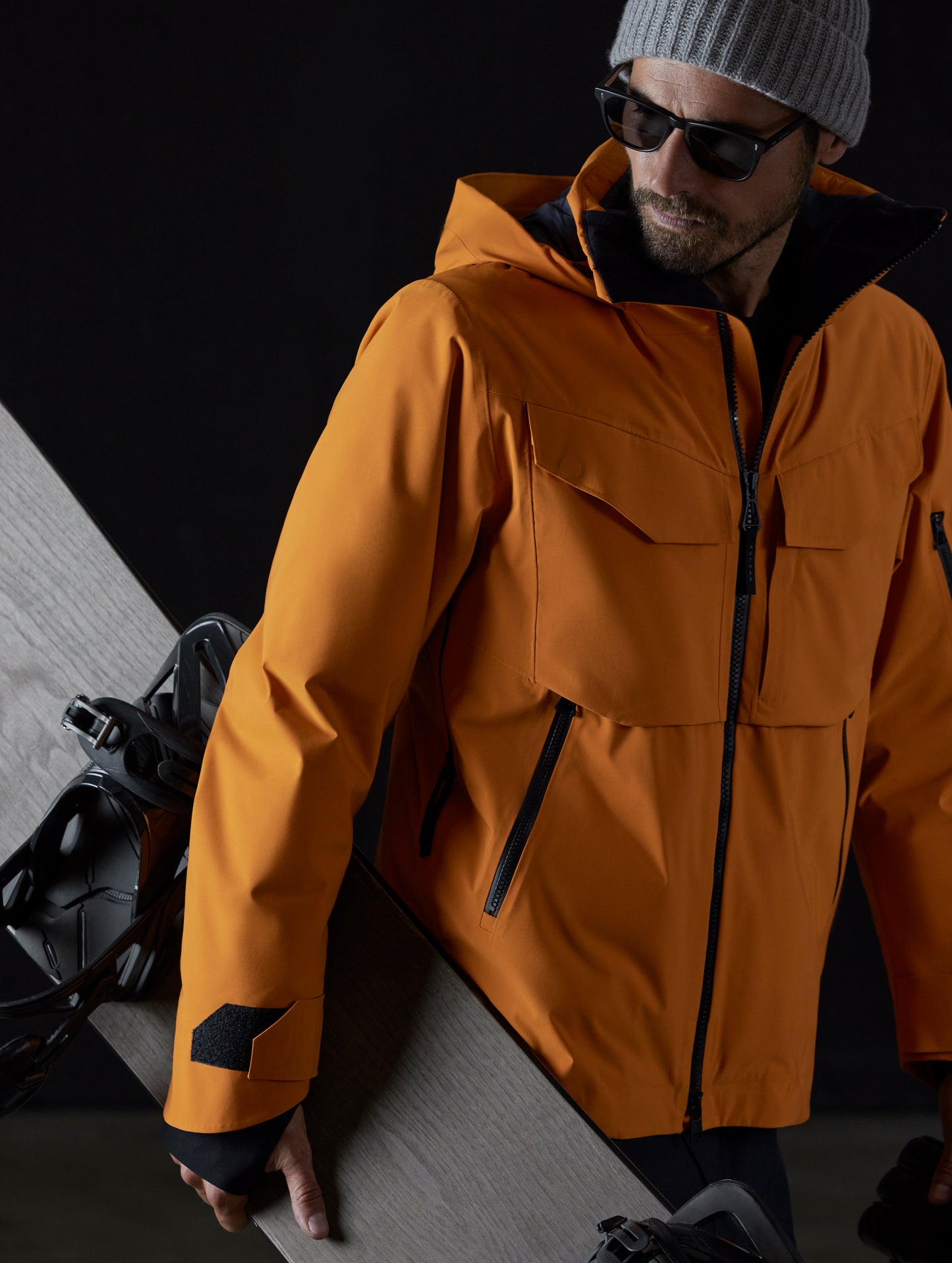 Man wearing orange snow jacket from AETHER Apparel