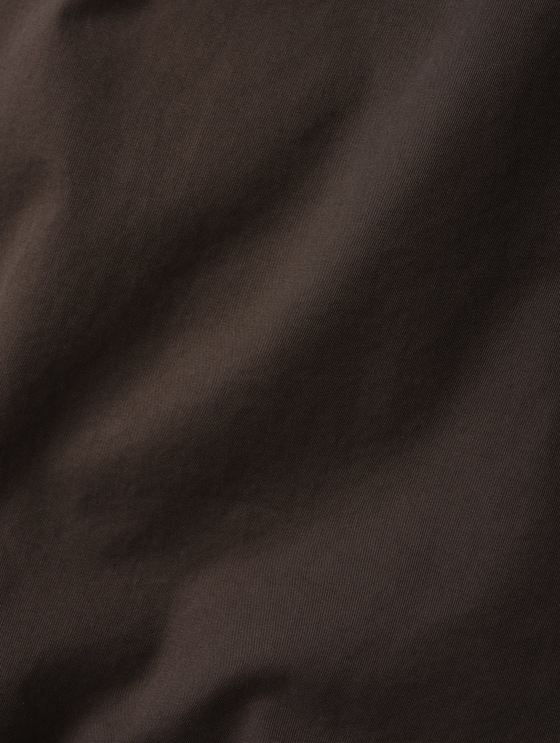 Closeup detailed view of the combed cotton construction on the Caden Work Shirt in Ash Brown from AETHER Apparel.
