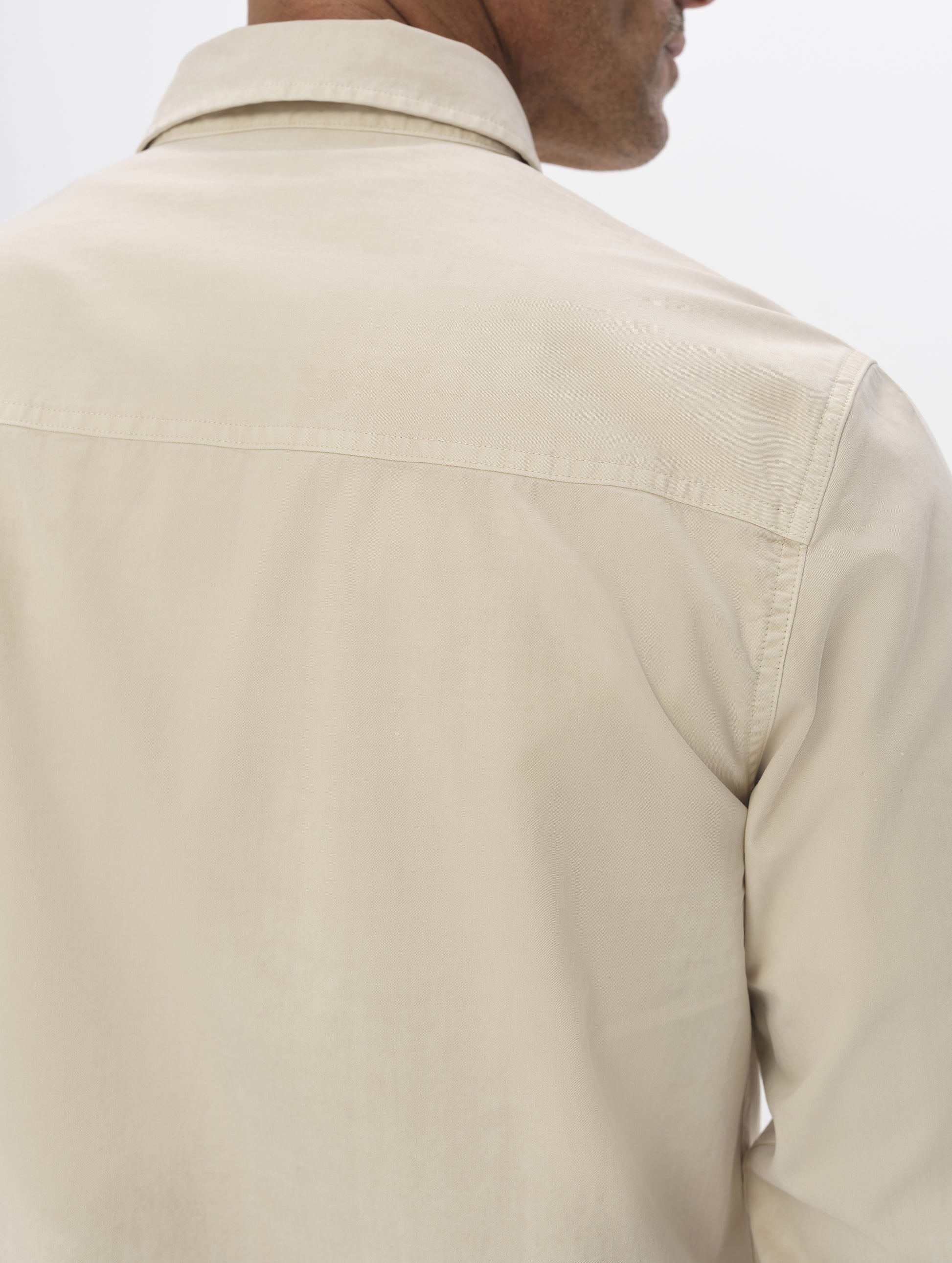 Closeup detailed view of the shoulders, collar, and back yoke on the Caden Work Shirt in Bone from AETHER Apparel.