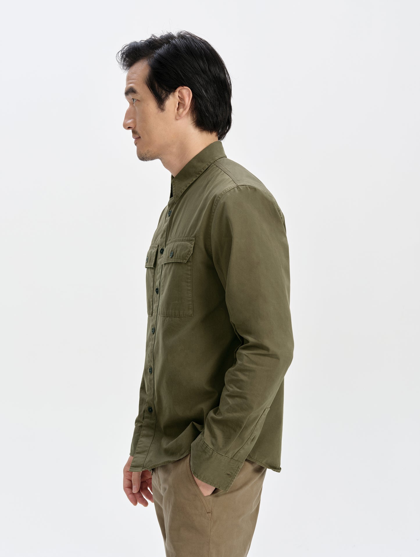 Side profile upper-body view of man wearing the Caden Work Shirt in Cadet from AETHER Apparel.