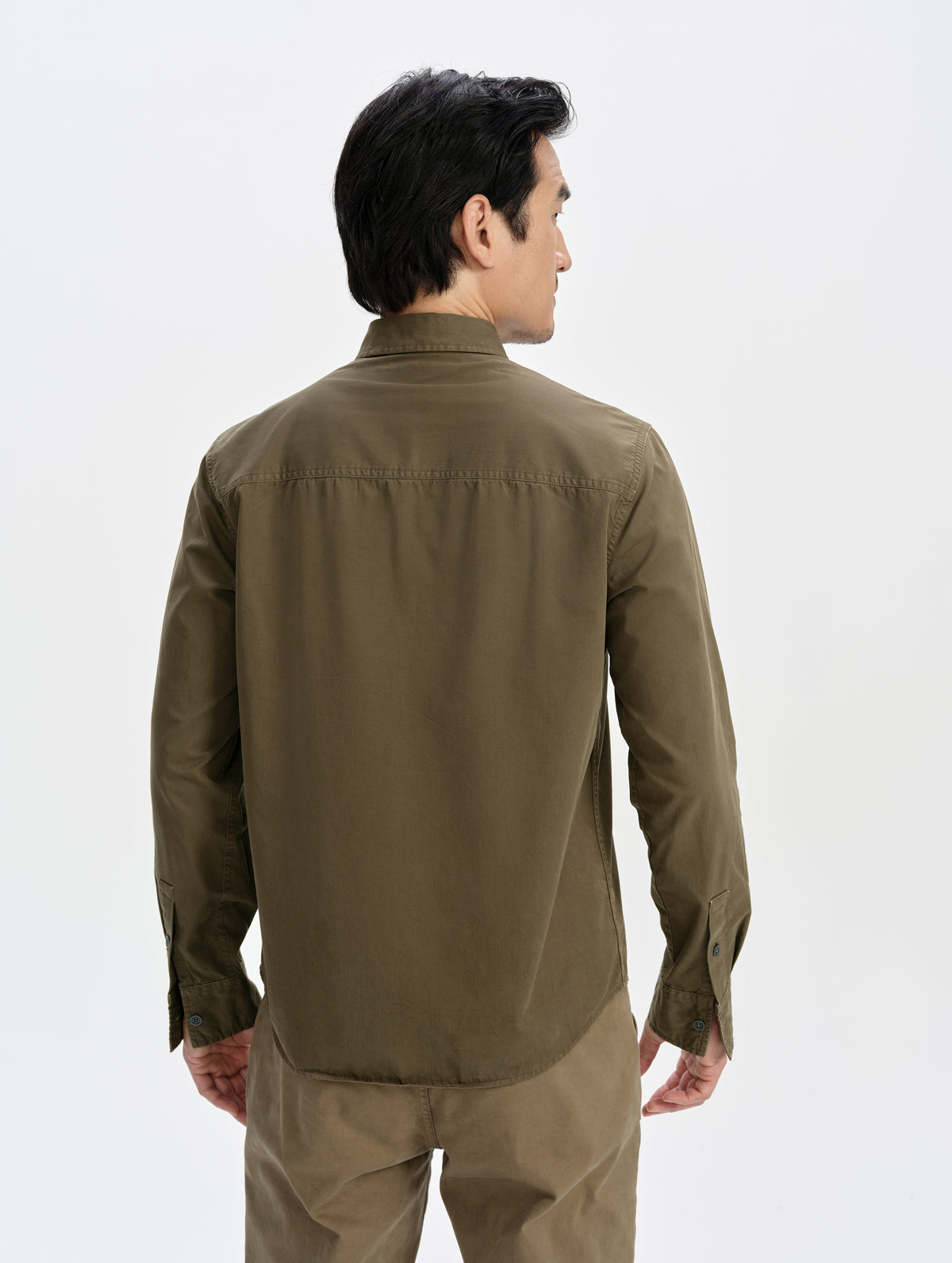 Rear upper-body view of man wearing the Caden Work Shirt in Cadet from AETHER Apparel.