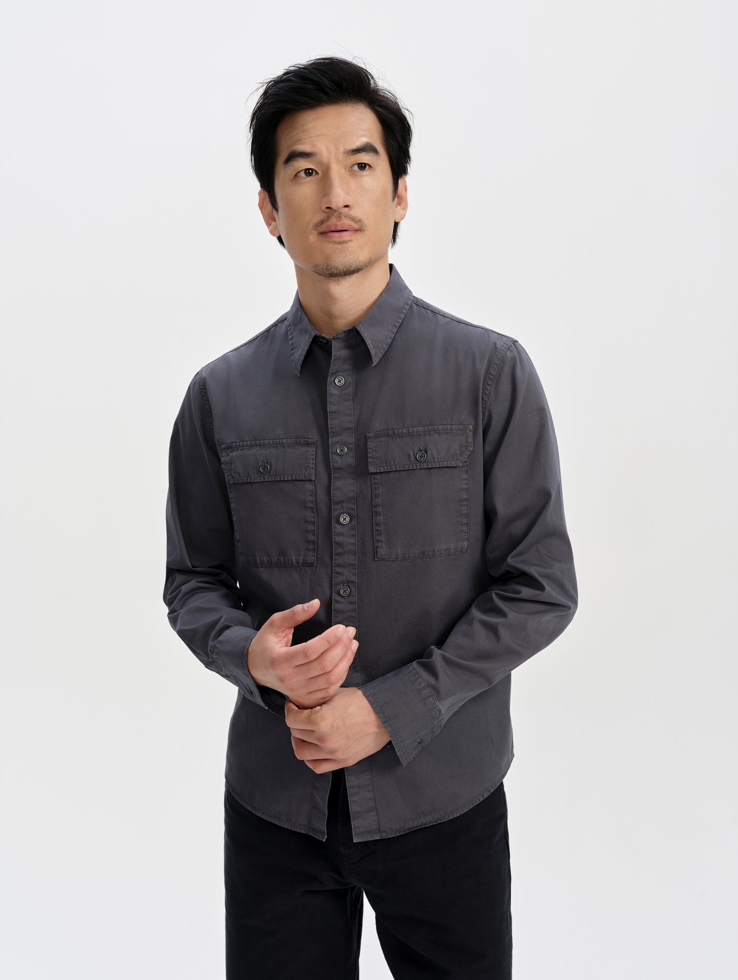 Front upper-body view of man wearing the Caden Work Shirt in Graphite from AETHER Apparel.