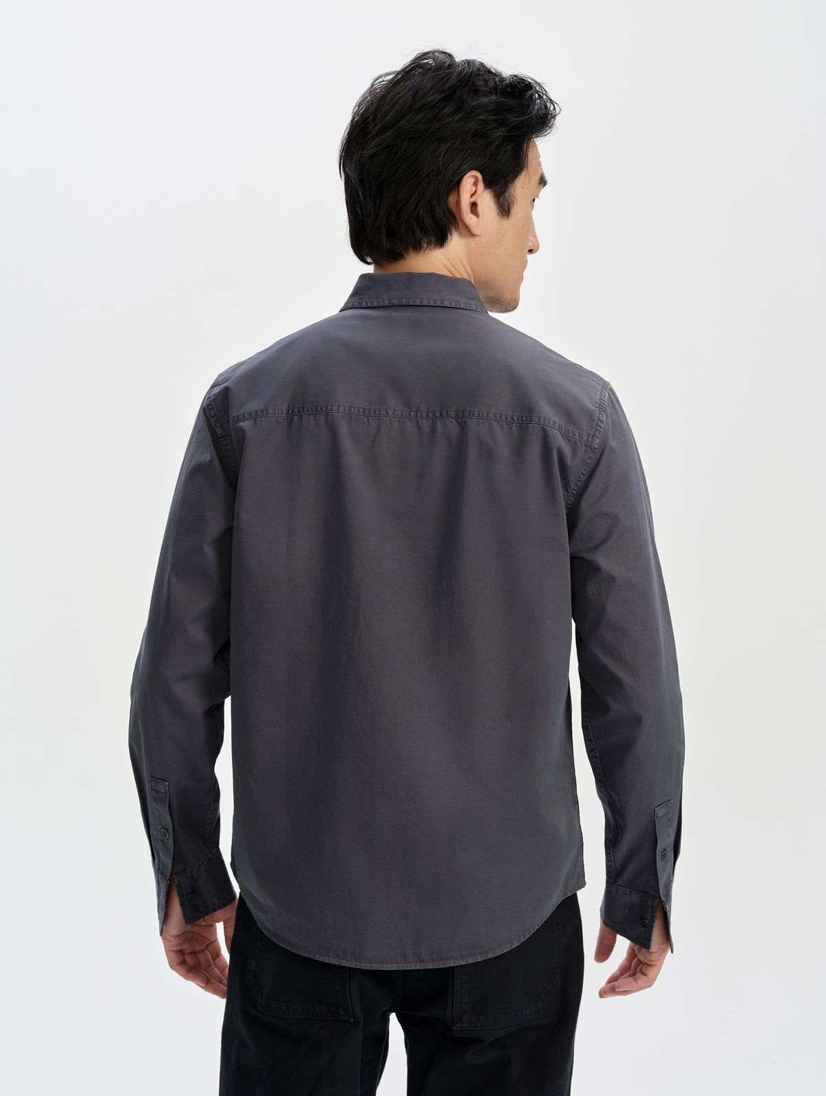 Rear upper-body view of man wearing the Caden Work Shirt in Graphite from AETHER Apparel.