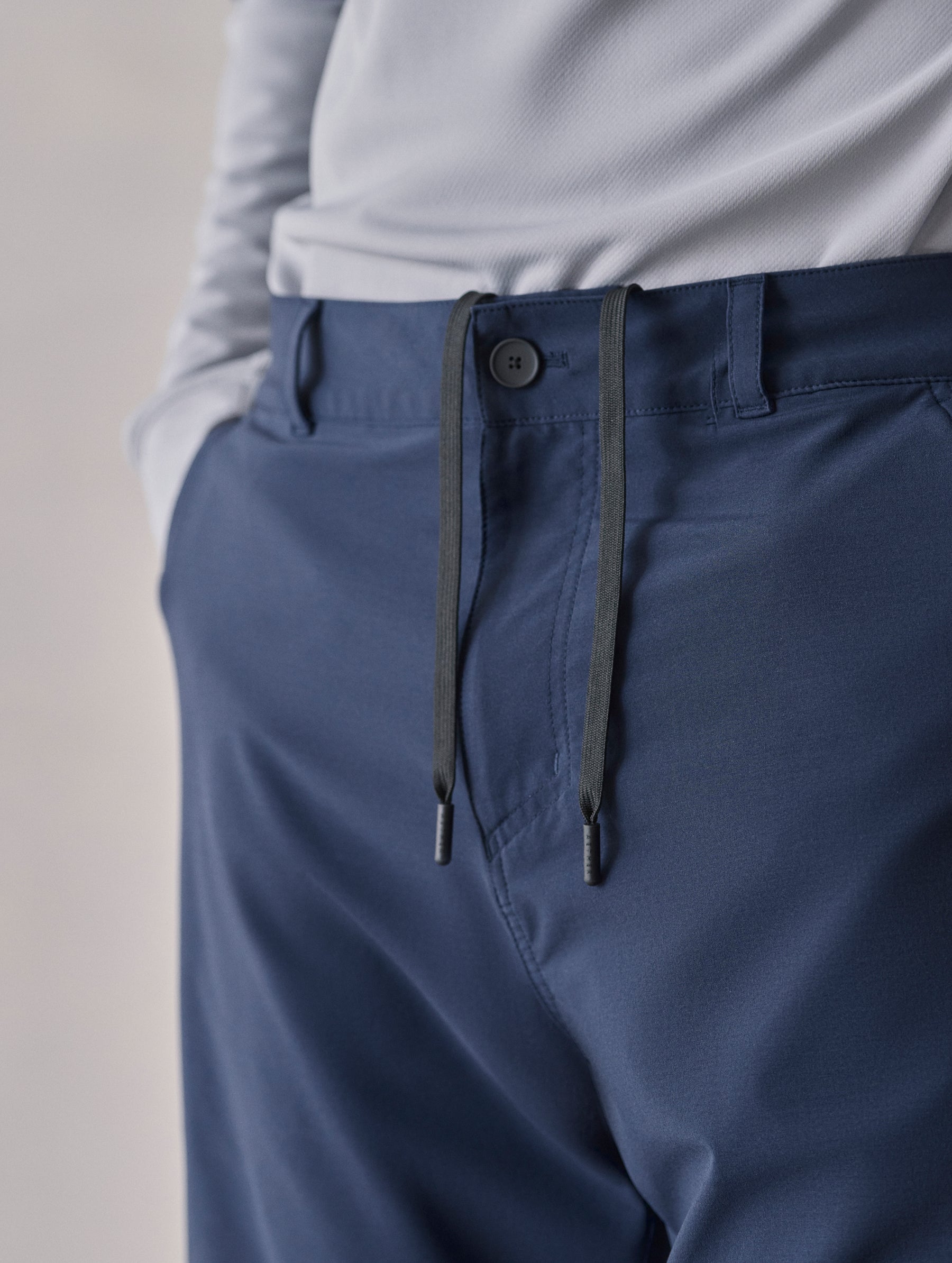 Closeup detailed shot of front closure and drawcord on Catalina Submersible Short in Total Eclipse dark blue from AETHER Apparel.