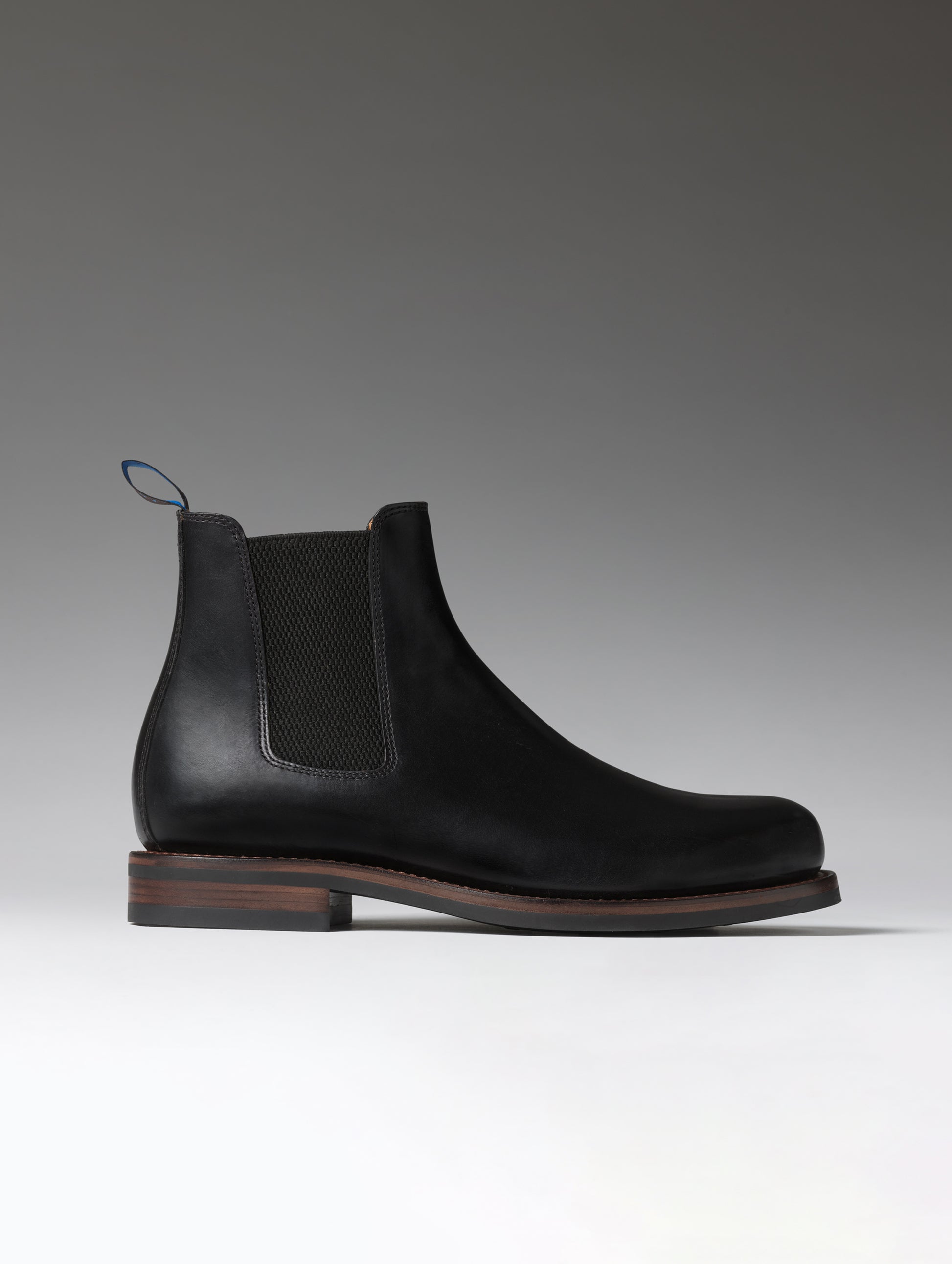 Side profile view of the City Chelsea Boot in Onyx Black from AETHER Apparel.