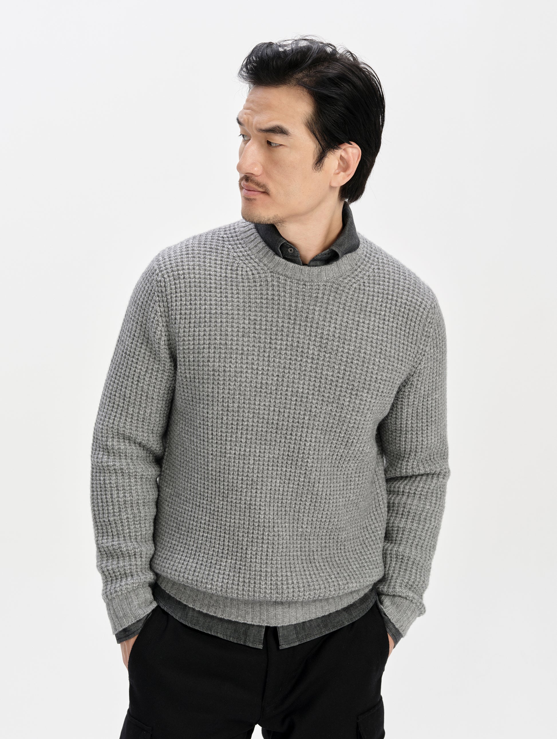 Front upper-body view of man wearing the Coastal Waffle Sweater in Heather Grey from AETHER Apparel.