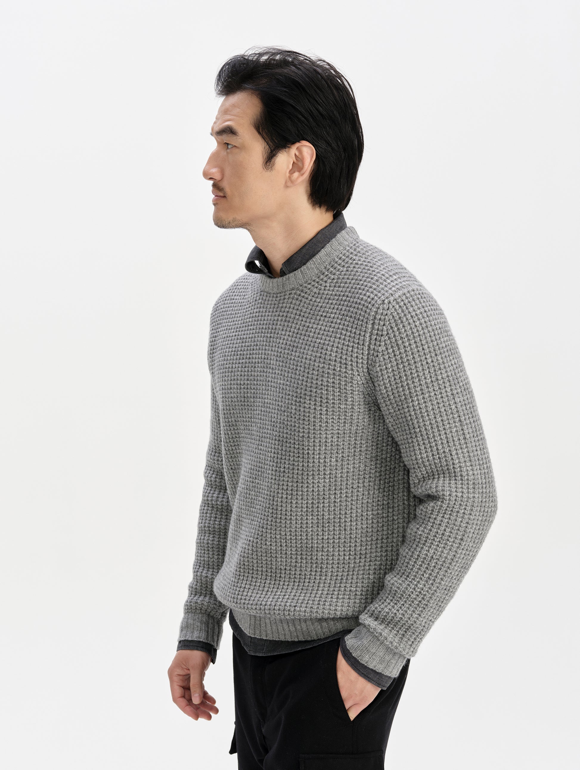 Side profile upper-body view of man wearing the Coastal Waffle Sweater in Heather Grey from AETHER Apparel.