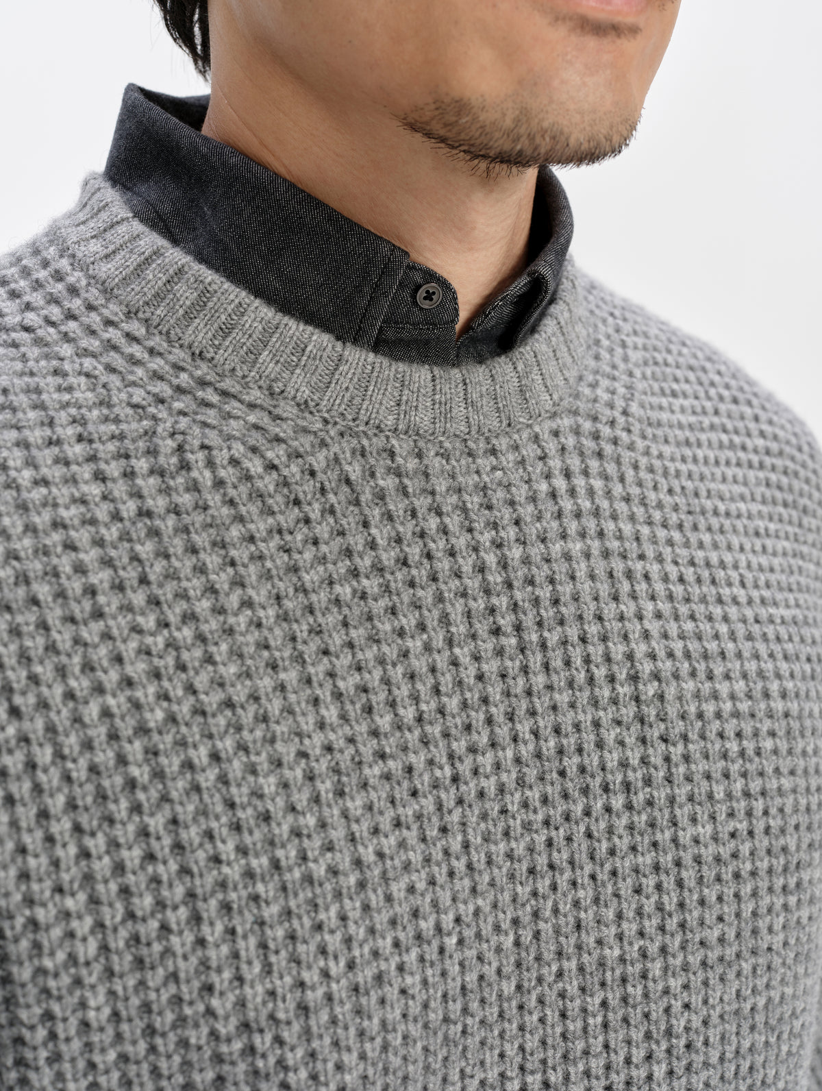 Closeup detailed view of the rib-knit collar on the Coastal Waffle Sweater in Heather Grey from AETHER Apparel.
