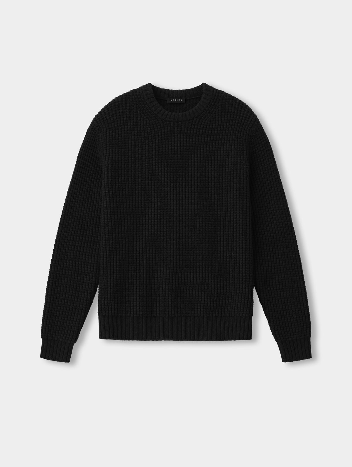 Flat lay of the Coastal Waffle Sweater in Onyx Black from AETHER Apparel.
