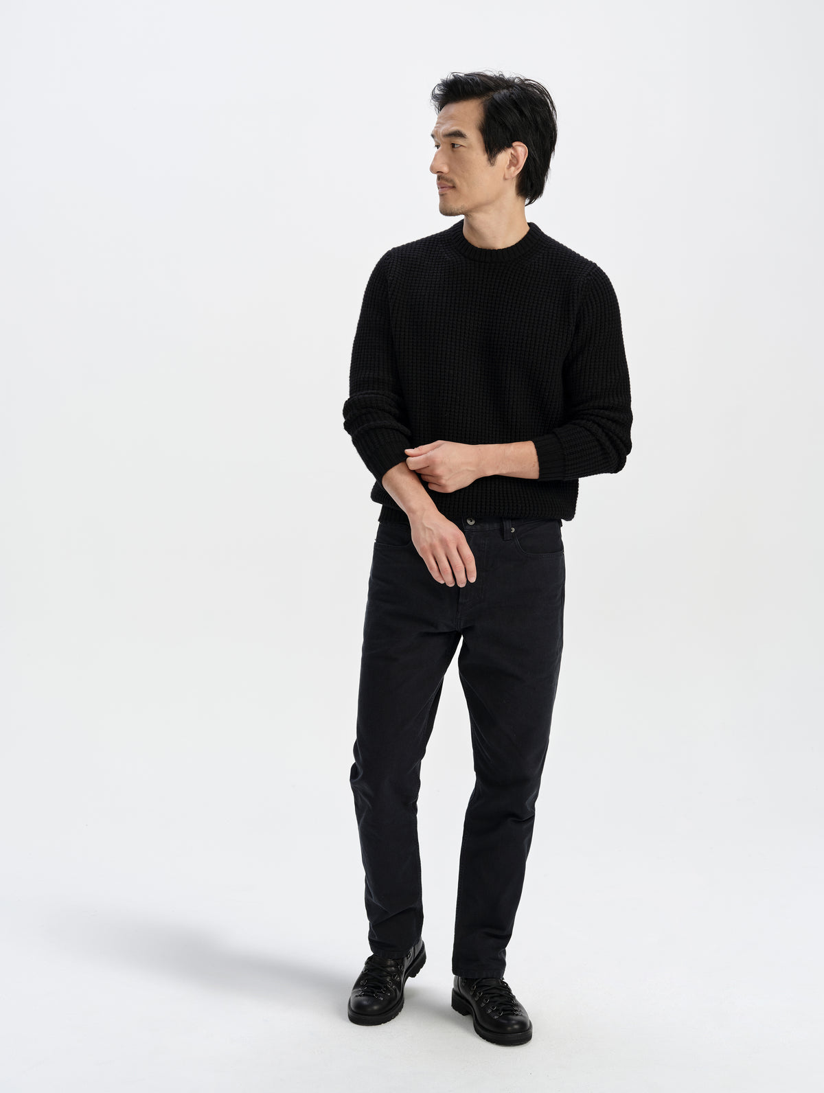 Front full-body view of man wearing the Coastal Waffle Sweater in Onyx Black from AETHER Apparel.