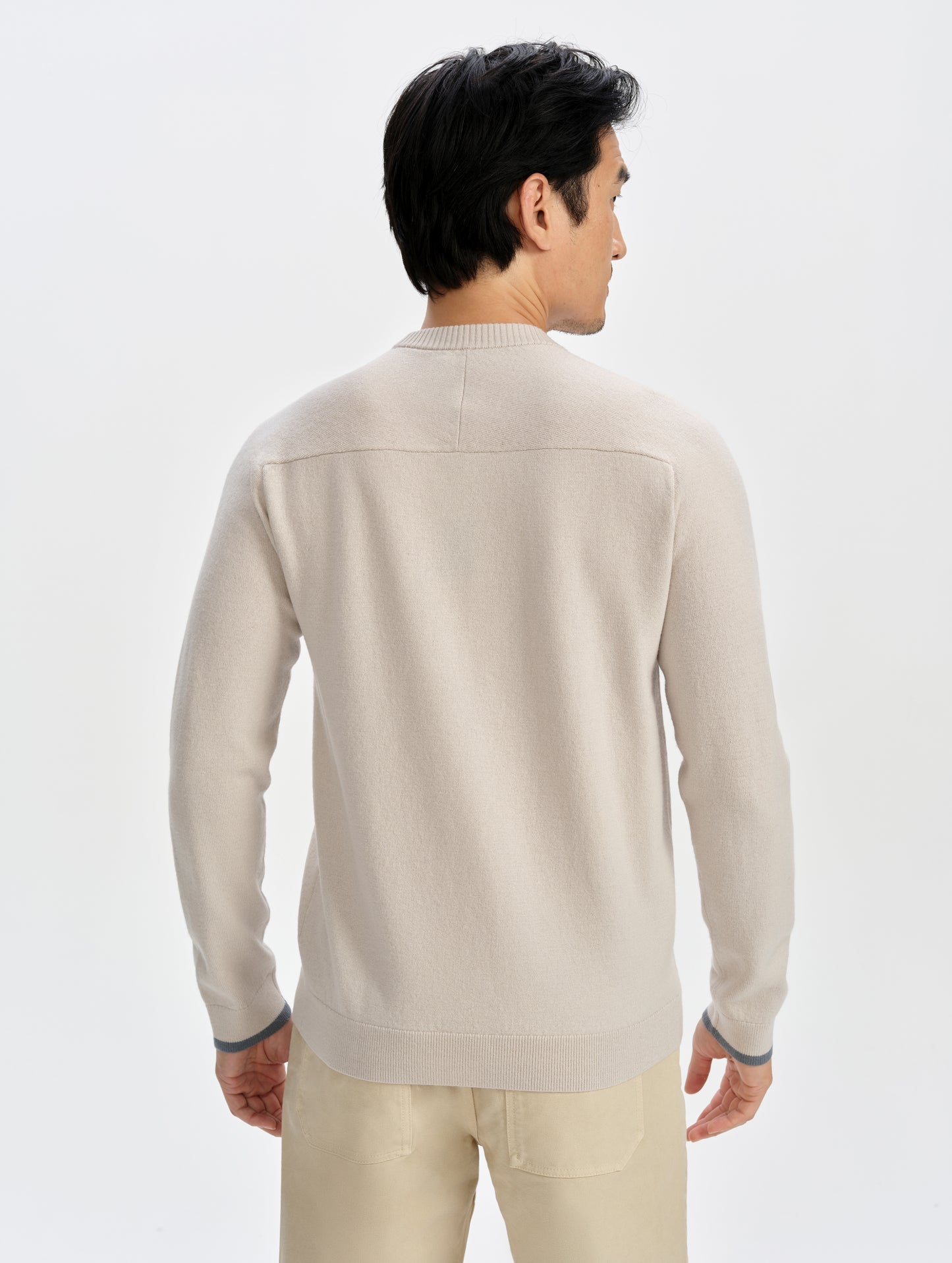 Rear upper-body view of man wearing the Corbin Sweater in Bone from AETHER Apparel.