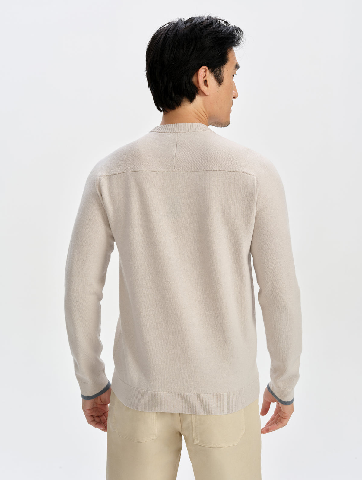 Rear upper-body view of man wearing the Corbin Sweater in Bone from AETHER Apparel.