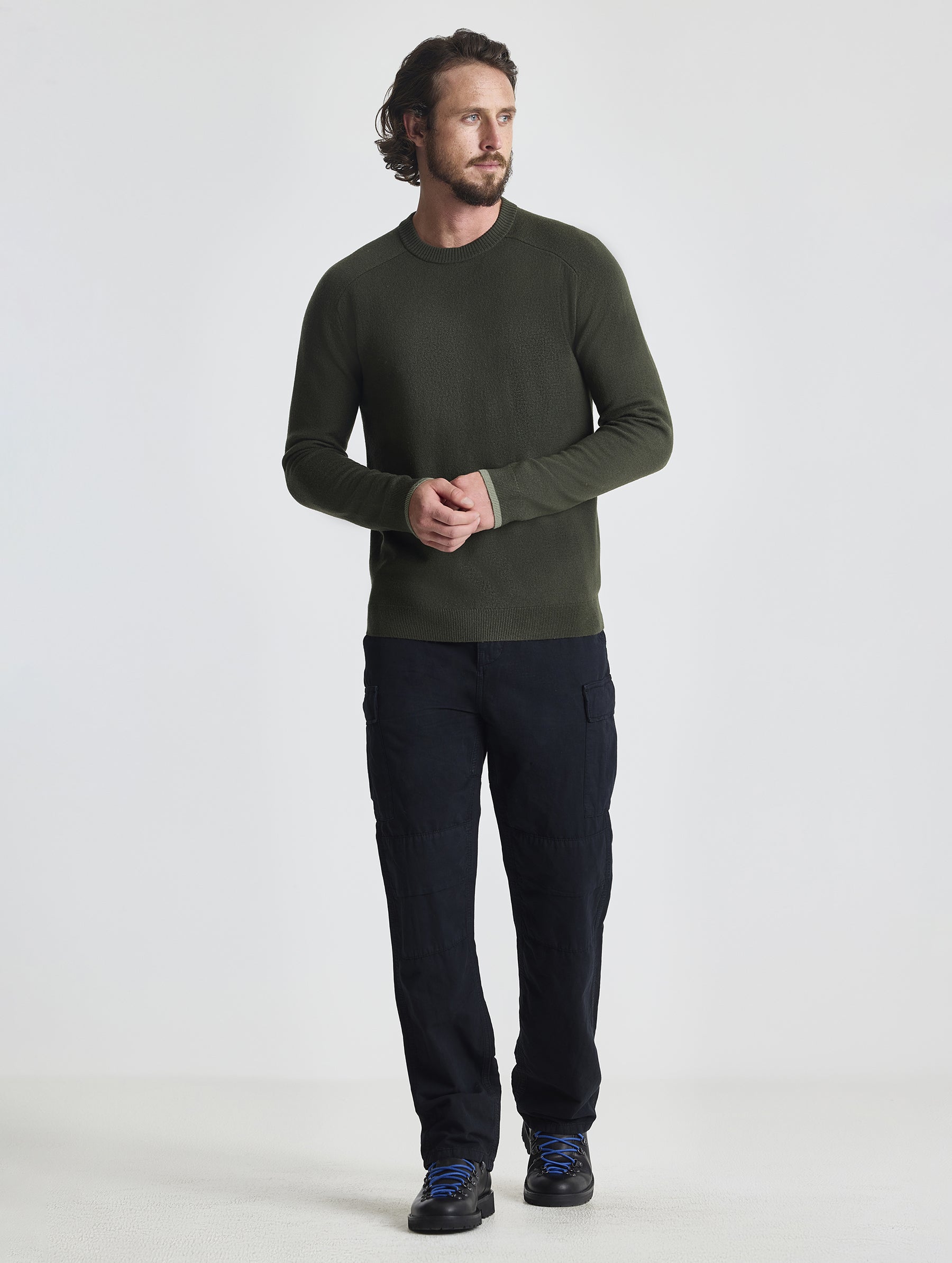 Full body view of man wearing Corbin Sweater in Forest Green from AETHER Apparel.