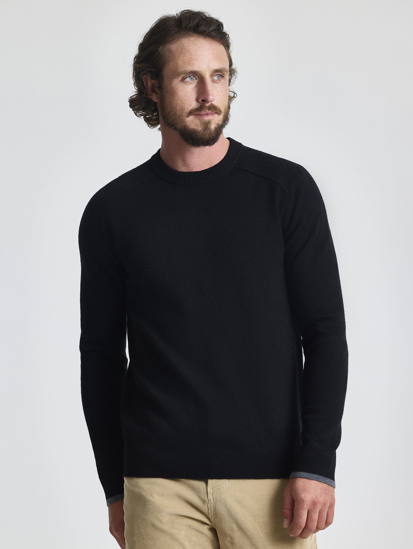 Front view of man wearing Corbin Sweater in Onyx Black from AETHER Apparel. 