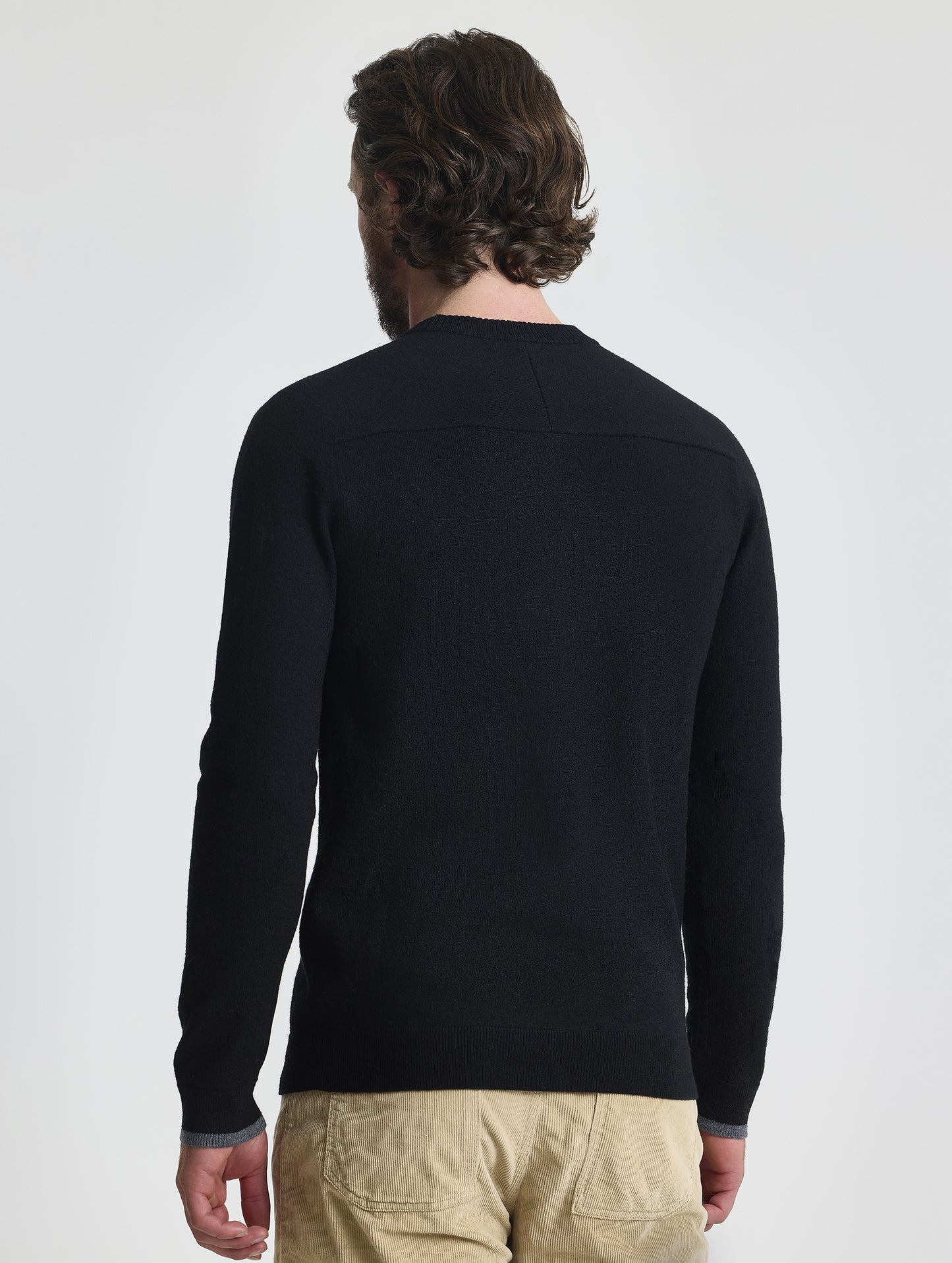 Rear view of man wearing Corbin Sweater in Onyx Black from AETHER Apparel. 