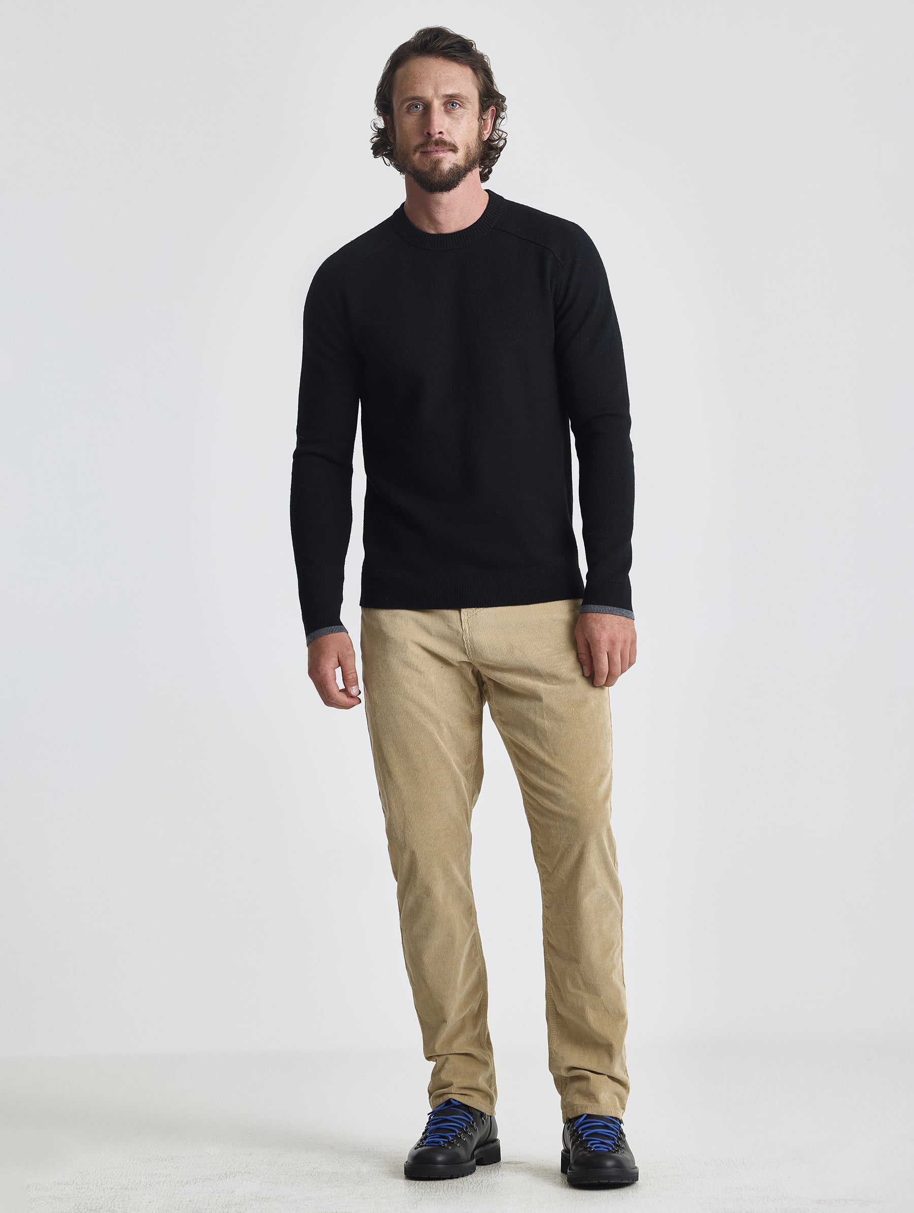 Full body view of man wearing Corbin Sweater in Onyx Black from AETHER Apparel. 