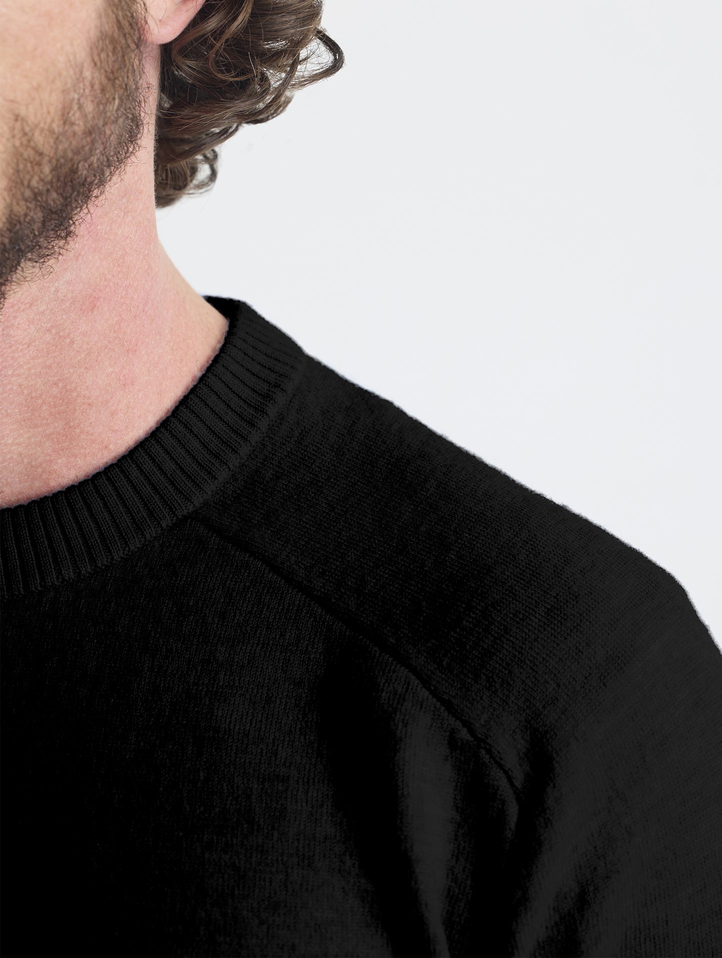 Closeup detail view of left shoulder of Corbin Sweater in Onyx Black from AETHER Apparel. 