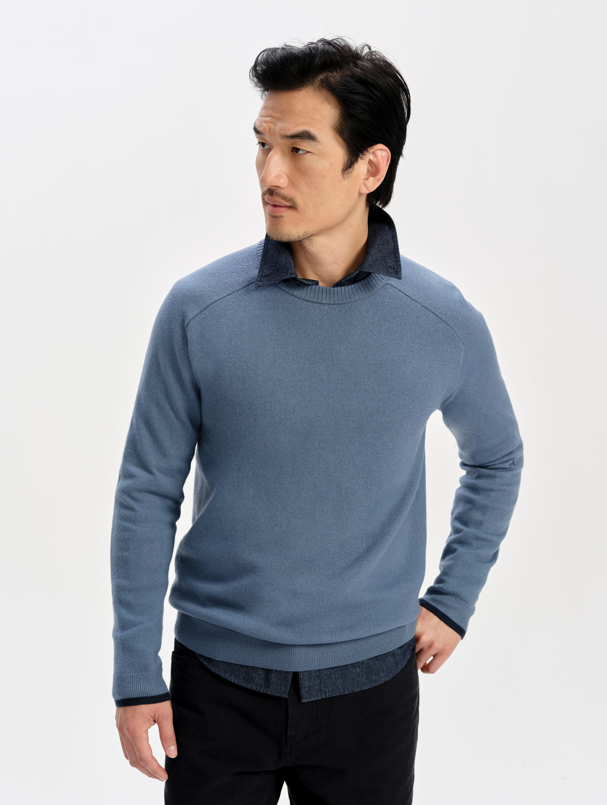 Front upper-body view of man wearing the Corbin Sweater in Portal Blue from AETHER Apparel.